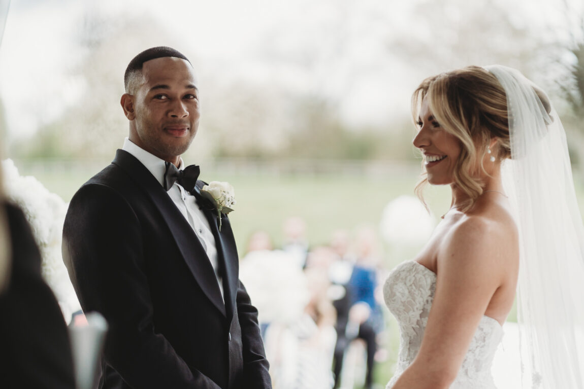 Bride and groom smiling at each other during their ceremony, documentary wedding photography by Matt Wing