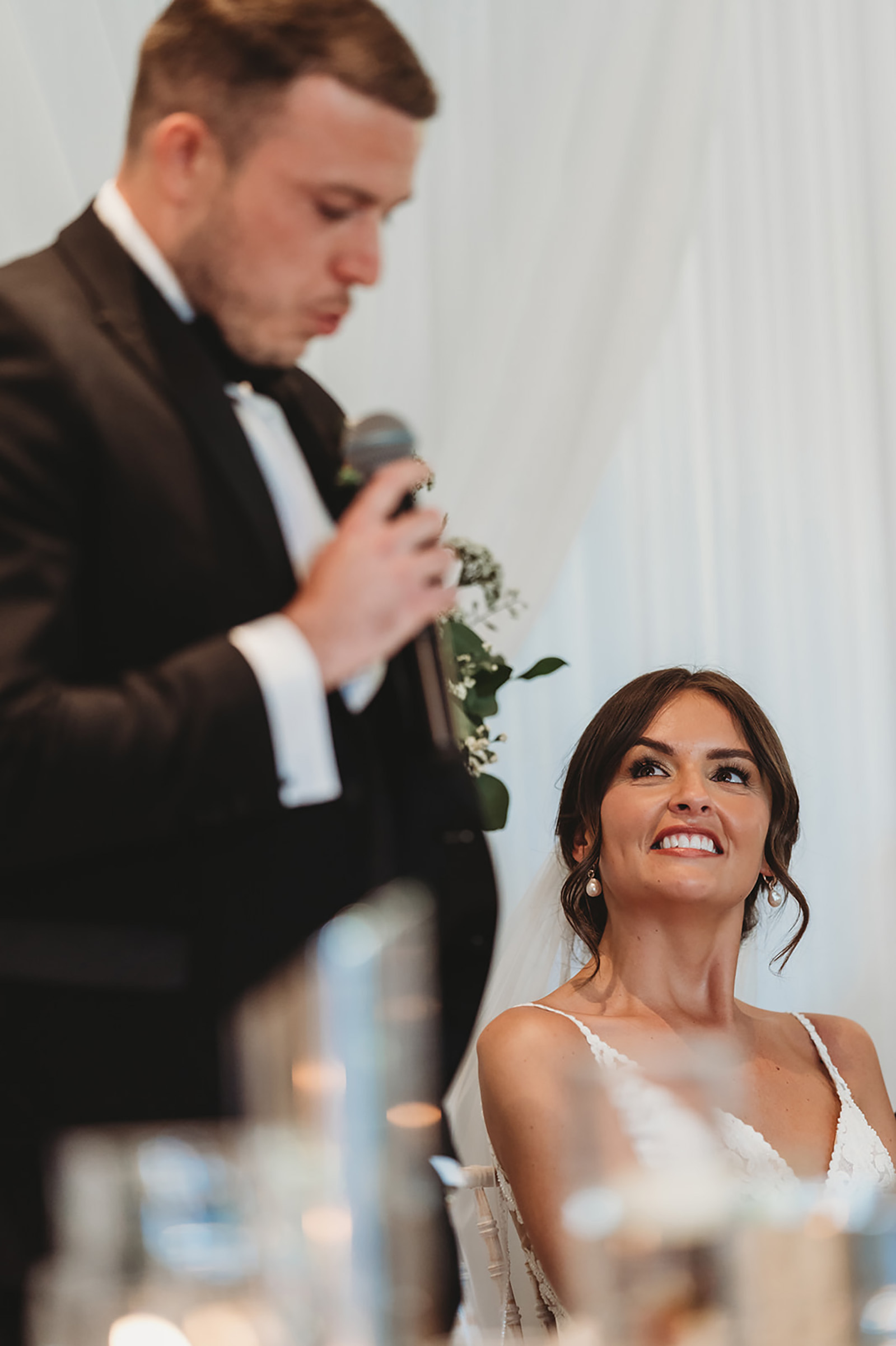 Bride laughing during a speech at The Orangery Maidstone, candid coverage