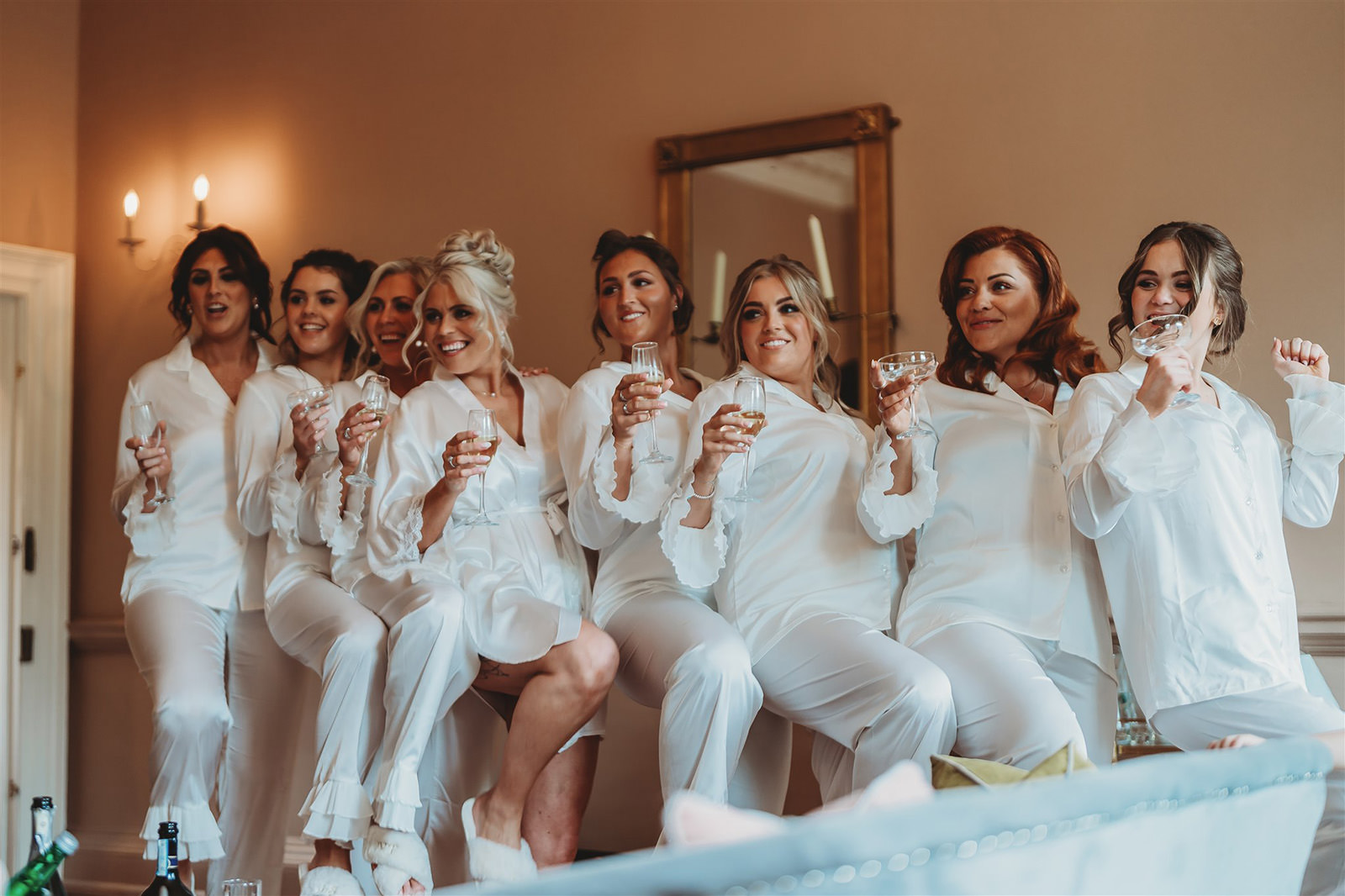 Bridal party in pyjamas raising a toast on the wedding morning, unposed wedding photography
