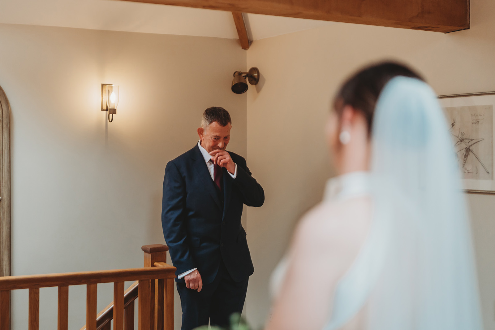 A father seeing his daughter in her wedding dress for the first time, unposed documentary photograph