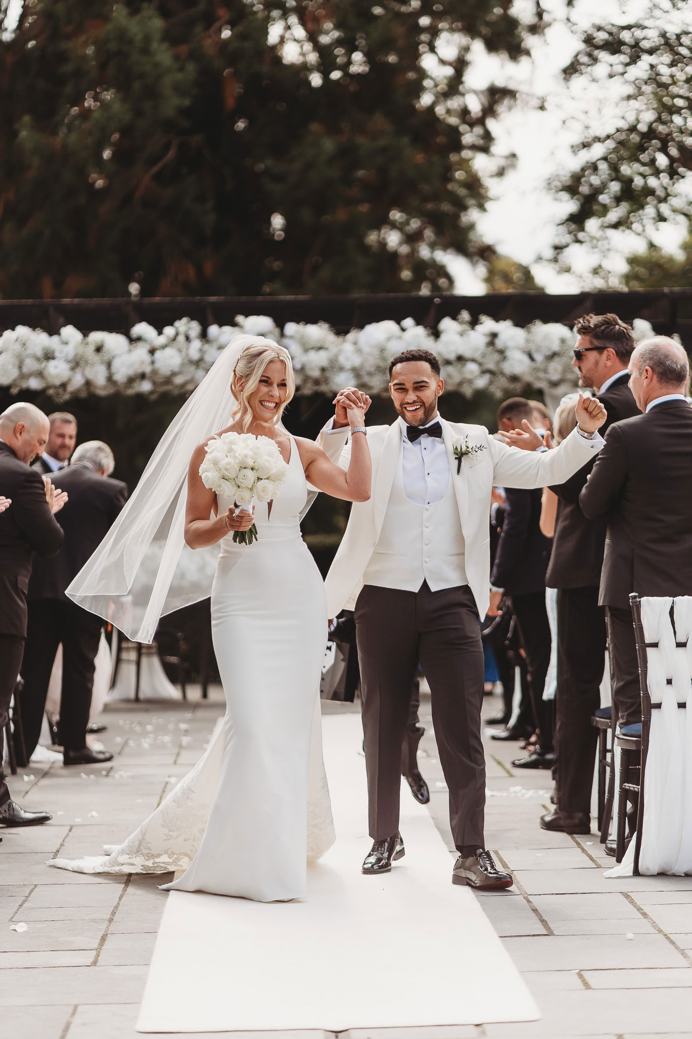 documentary wedding photography — couple leaving their outdoor ceremony just married