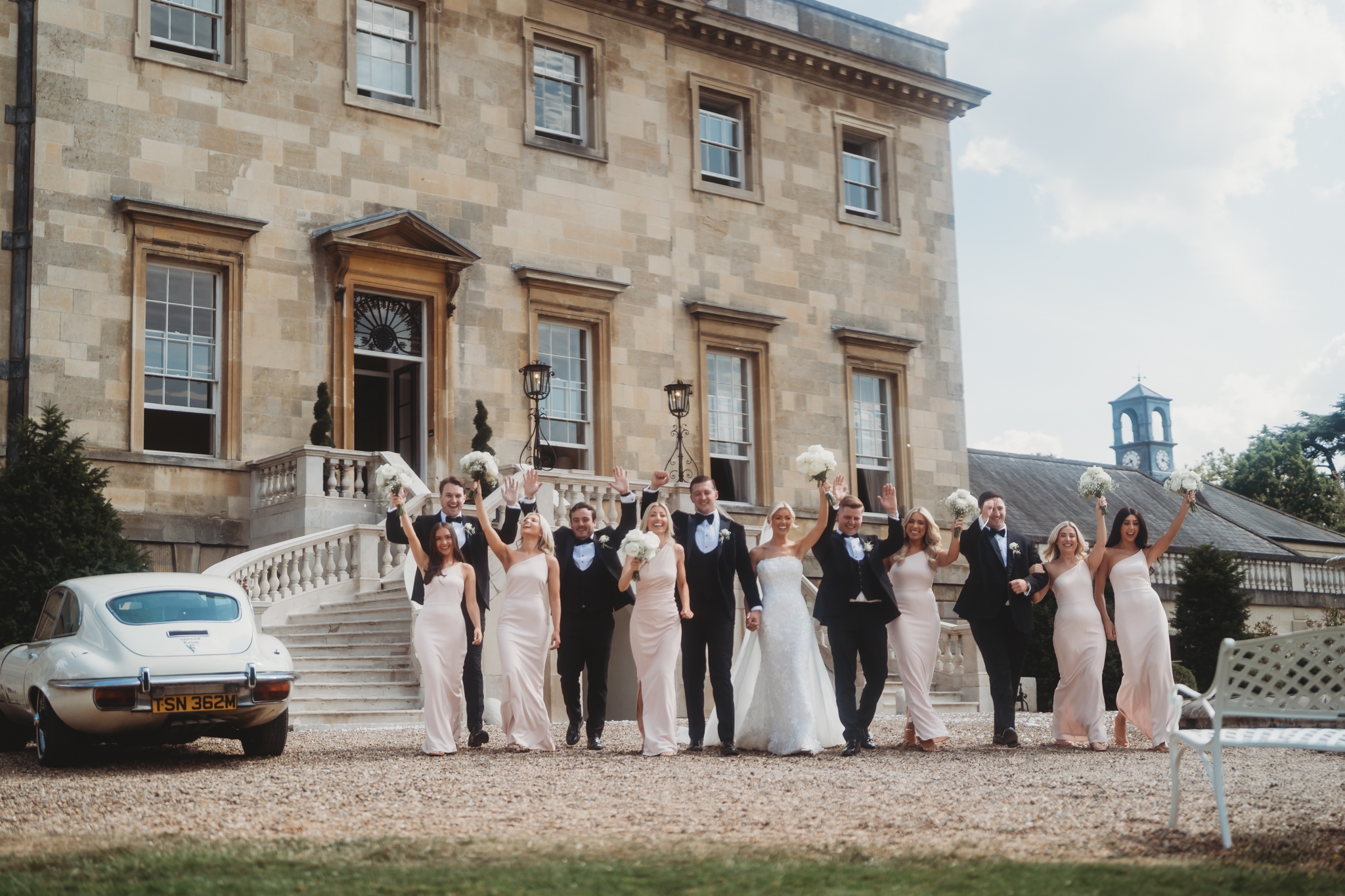 Bride and groom on the sweeping stairs of Botleys Mansion, Surrey