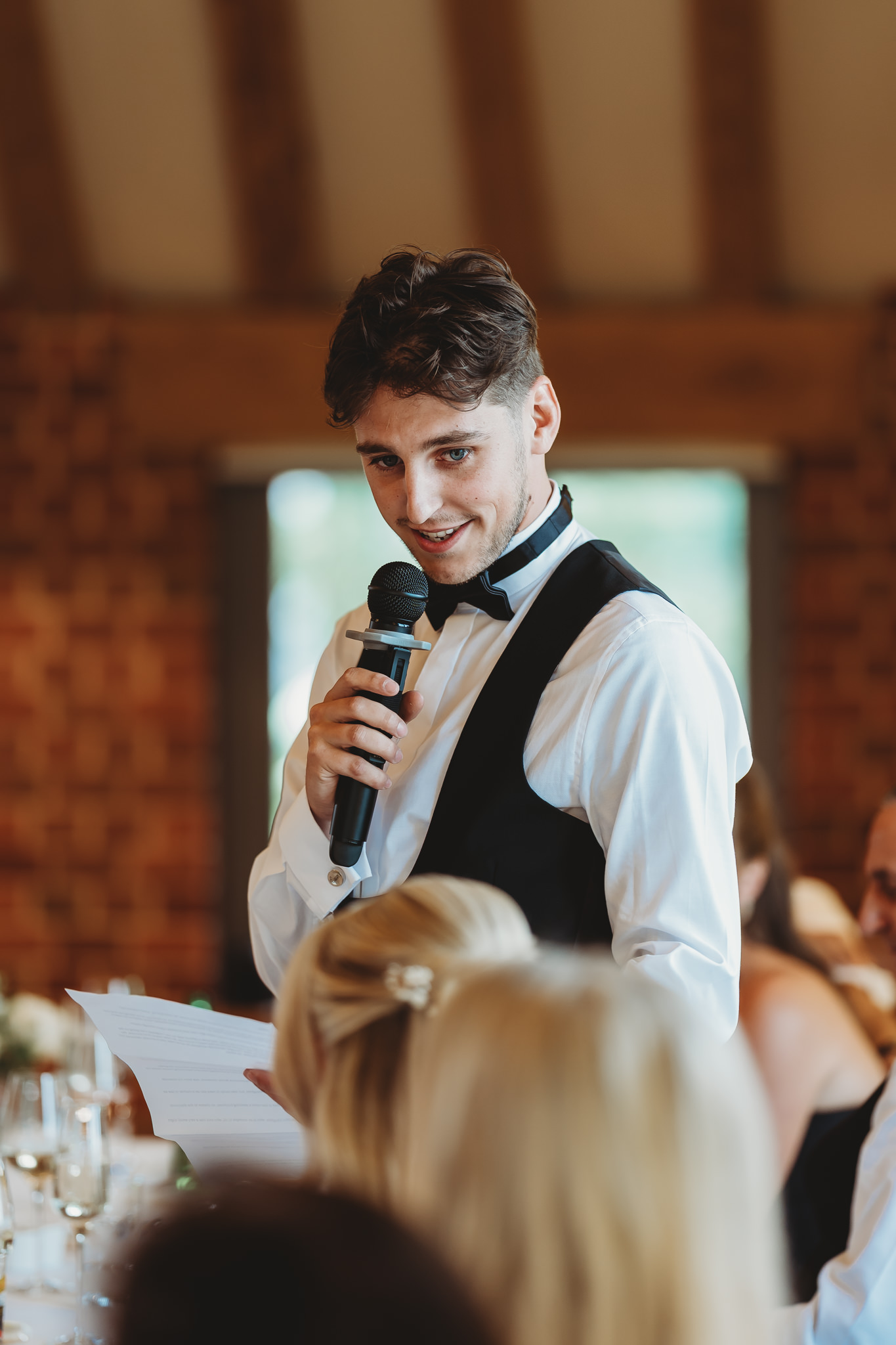 Ella & Ryan / Rackleys Barn 41 Wedding speeches under festoon lights at Rackleys Barn — Buckinghamshire wedding photographer