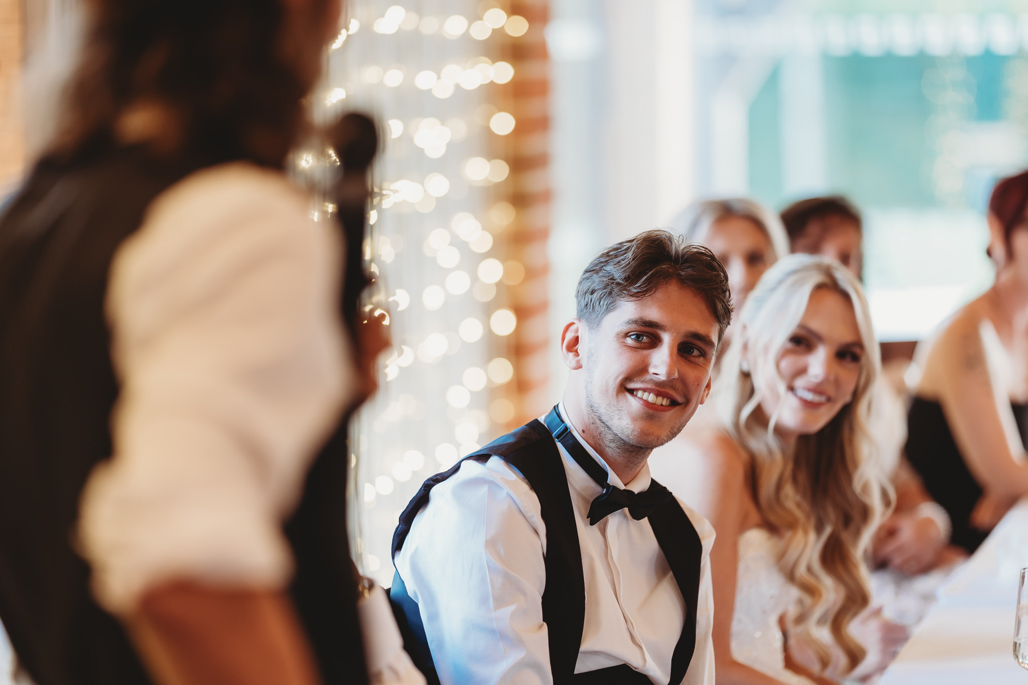Ella & Ryan / Rackleys Barn 48 Wedding speeches under festoon lights at Rackleys Barn — Buckinghamshire wedding photographer
