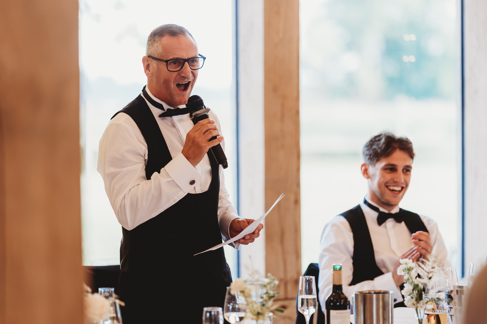 Ella & Ryan / Rackleys Barn 49 Wedding speeches under festoon lights at Rackleys Barn — Buckinghamshire wedding photographer
