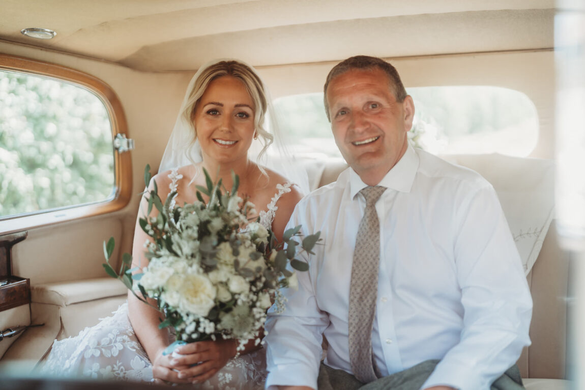 Bride and her dad in the vintage wedding car