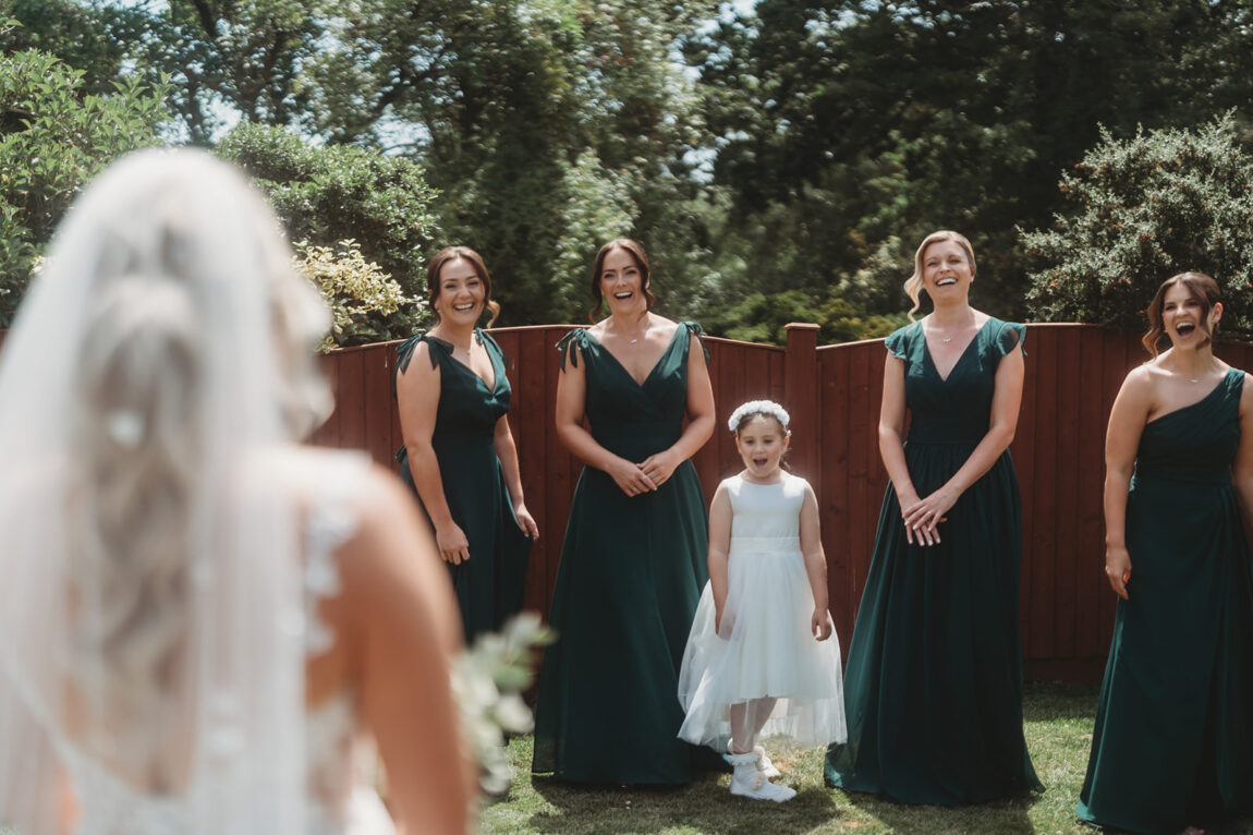 Bridesmaids seeing the bride for the first time