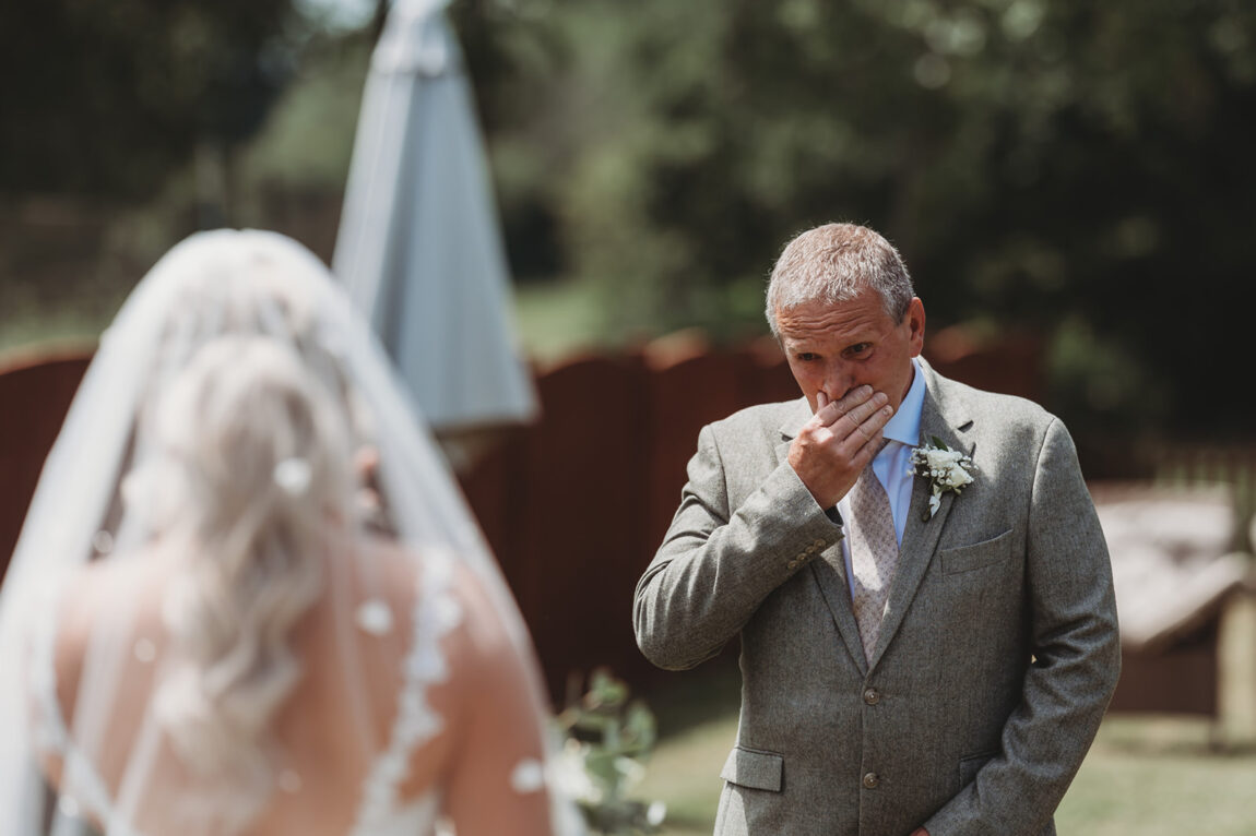 Father of the bride seeing his daughter in her dress for the first time