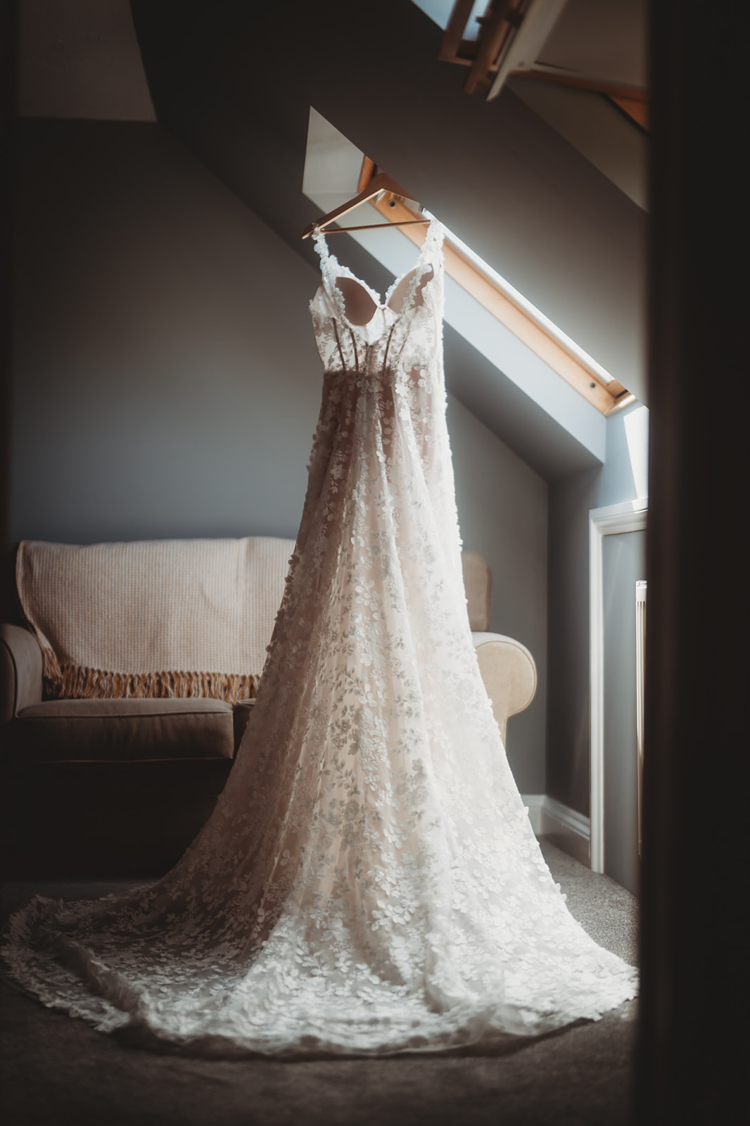 Wedding dress hanging in the window on the morning