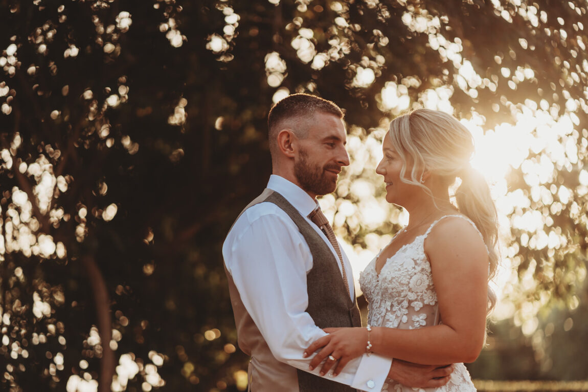 Sarah and Daniel embracing in the evening sun