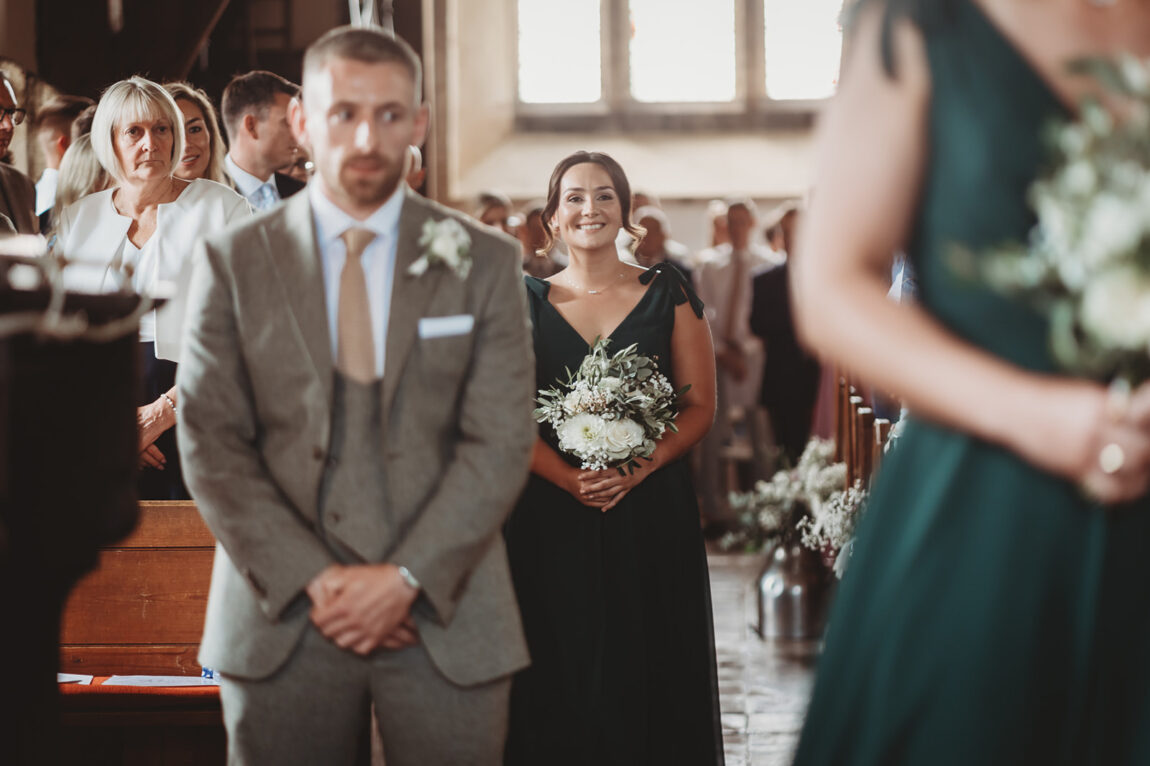 Groom turning to see his bride walk down the aisle