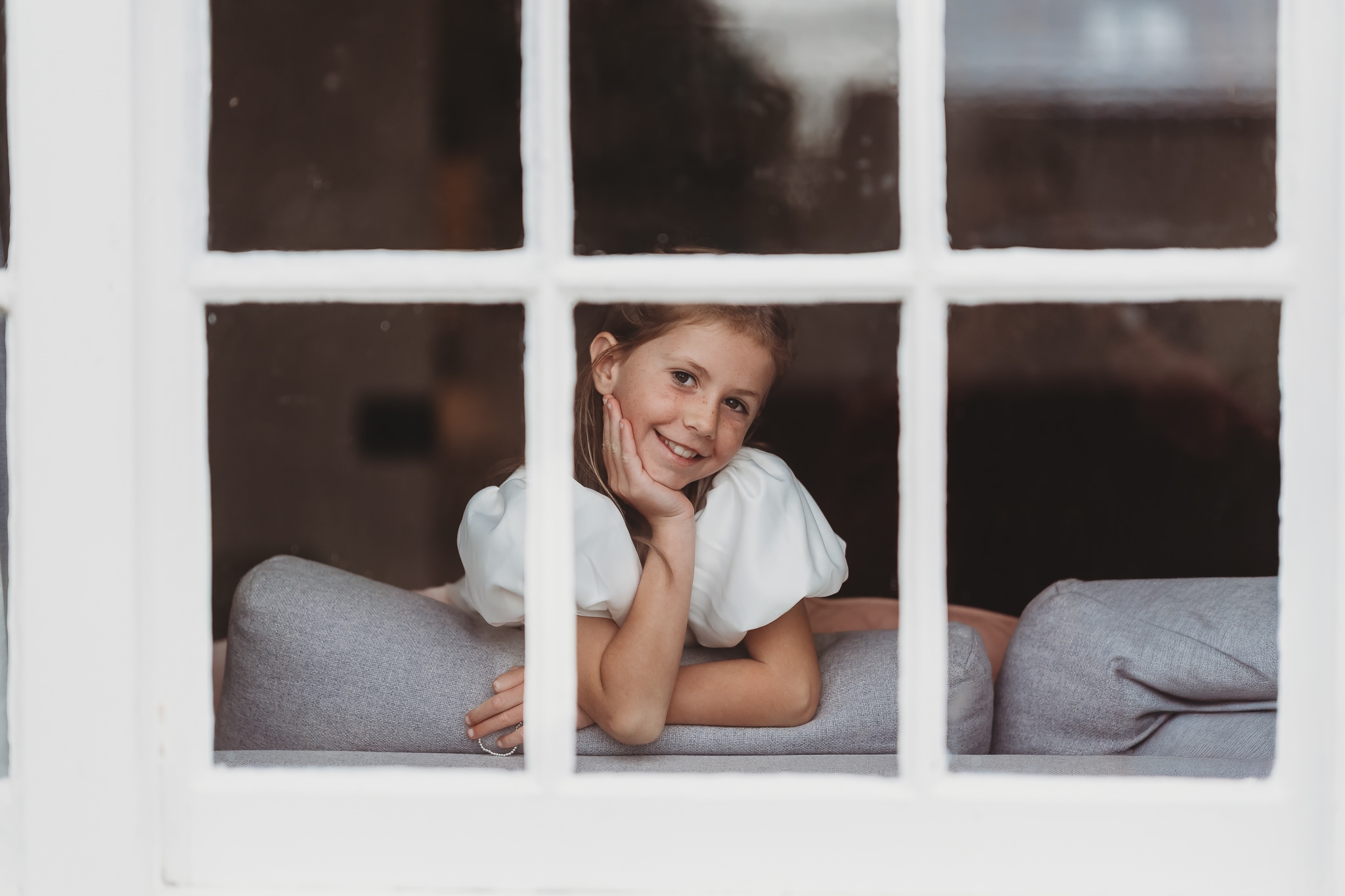 Laura & Liam / The Green Cornwall 8 Laura leaning in a cottage window frame at The Green Cornwall