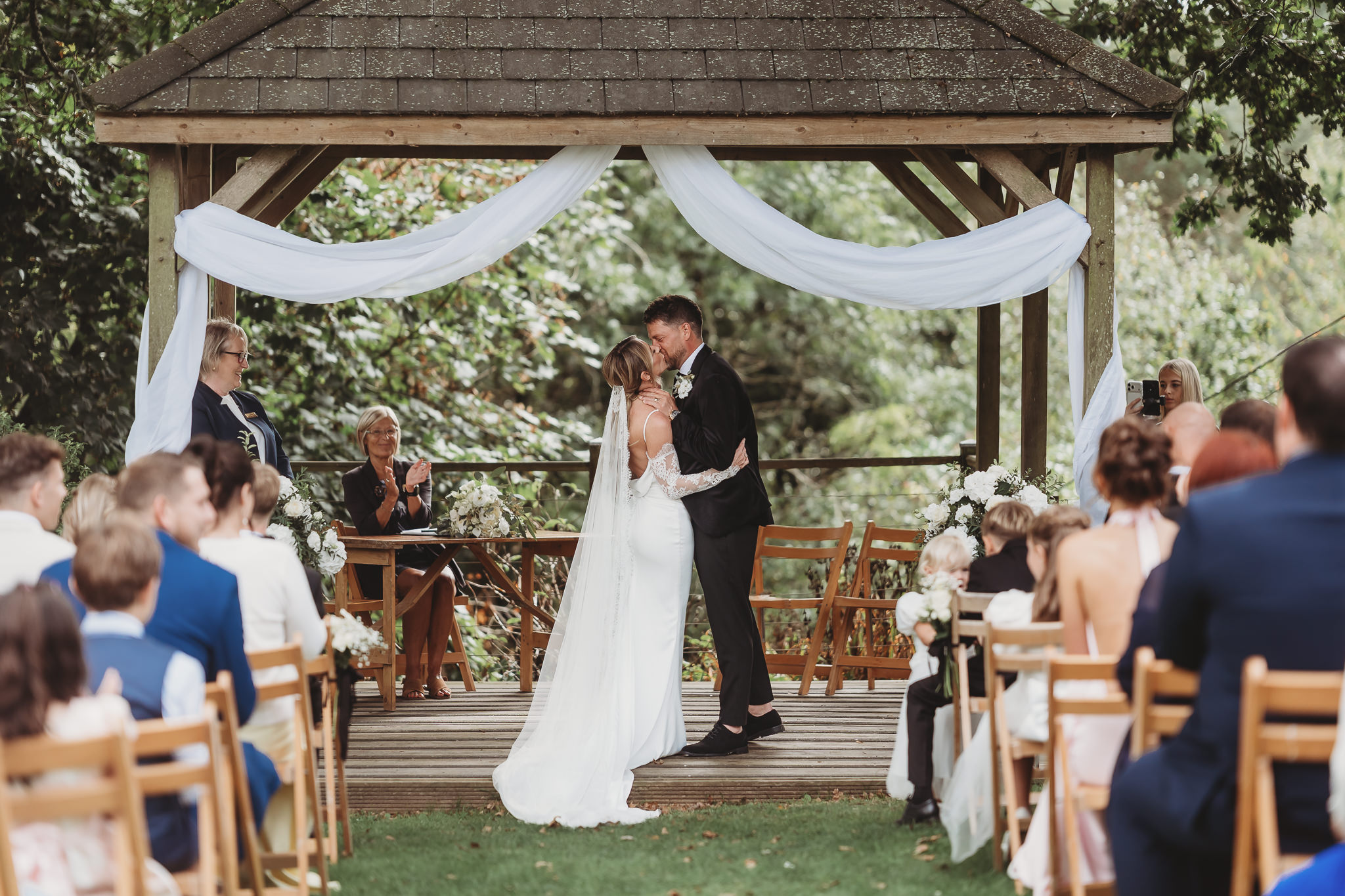Laura & Liam / The Green Cornwall 18 The first kiss under the oak arbour at The Green Cornwall