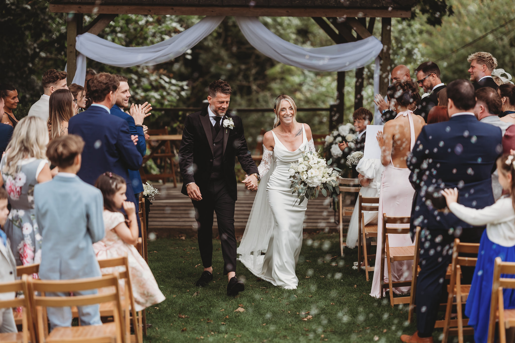 Laura & Liam / The Green Cornwall 19 Laura and Liam walking back down the aisle past their guests