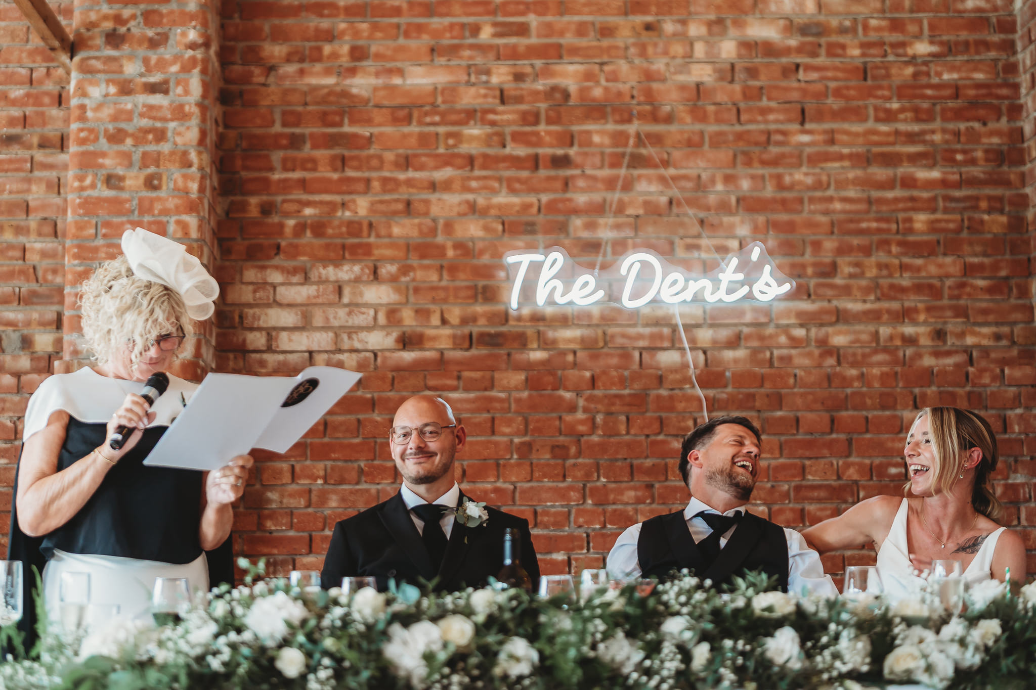 Laura & Liam / The Green Cornwall 28 Speeches at the top table under the neon sign at The Green Cornwall