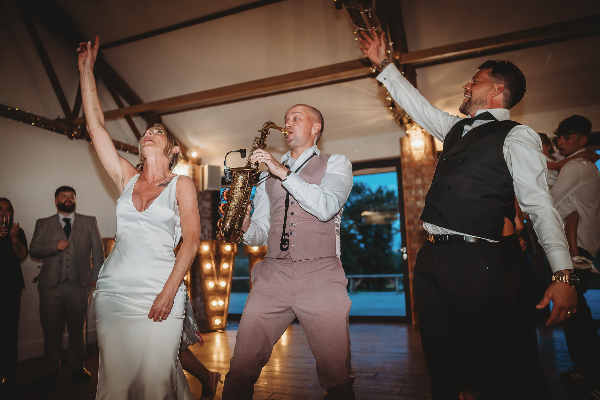Laura & Liam / The Green Cornwall 36 Laura and Liam celebrating on the dancefloor with a guest