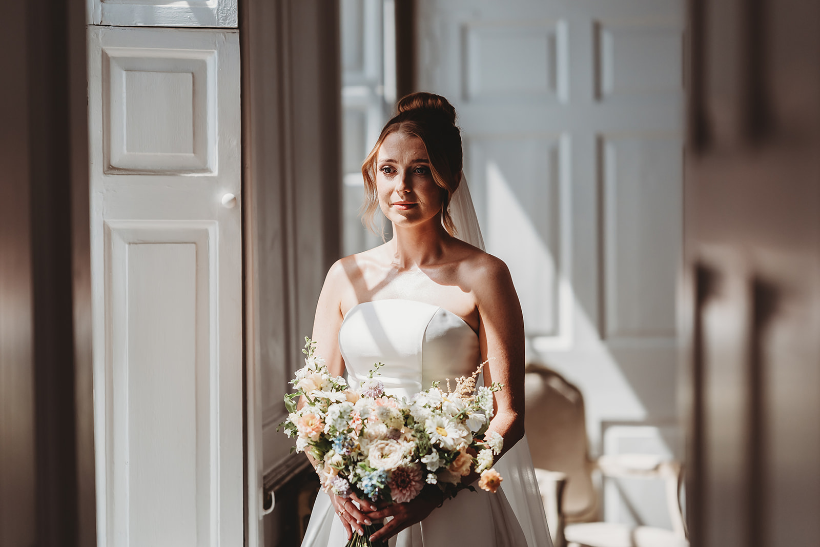 Bride ready for her Gosfield Hall wedding, with a first look from her dad