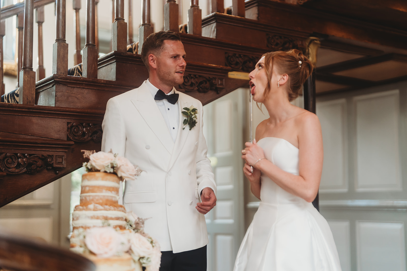 Cutting the cake by the grand staircase at Gosfield Hall