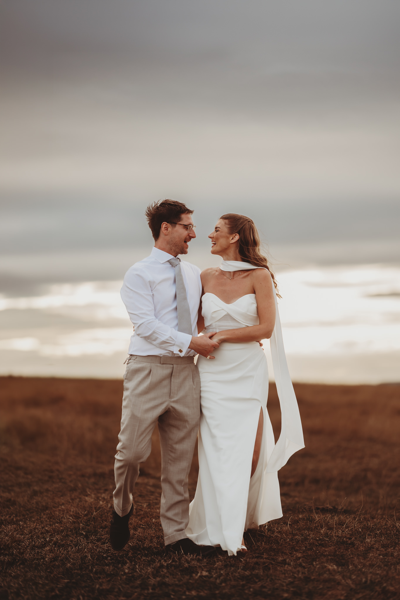 Mount Edgcumbe wedding photographer Matt Wing, a photo from another wedding: bride and groom holding each other on an open hillside