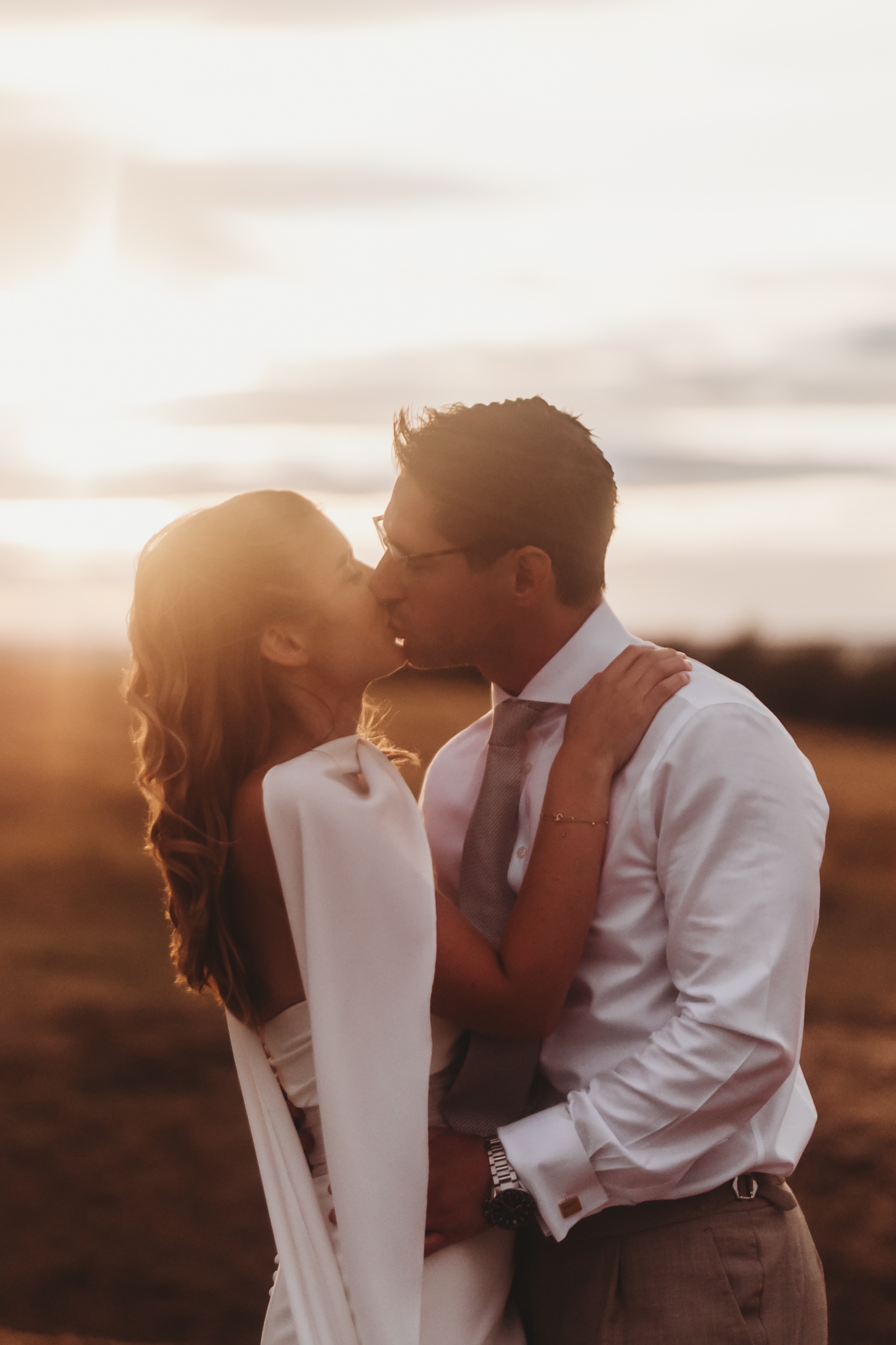 Beacon Crag wedding photographer Matt Wing, a photo from another wedding: couple kissing at golden hour, backlit by the low sun