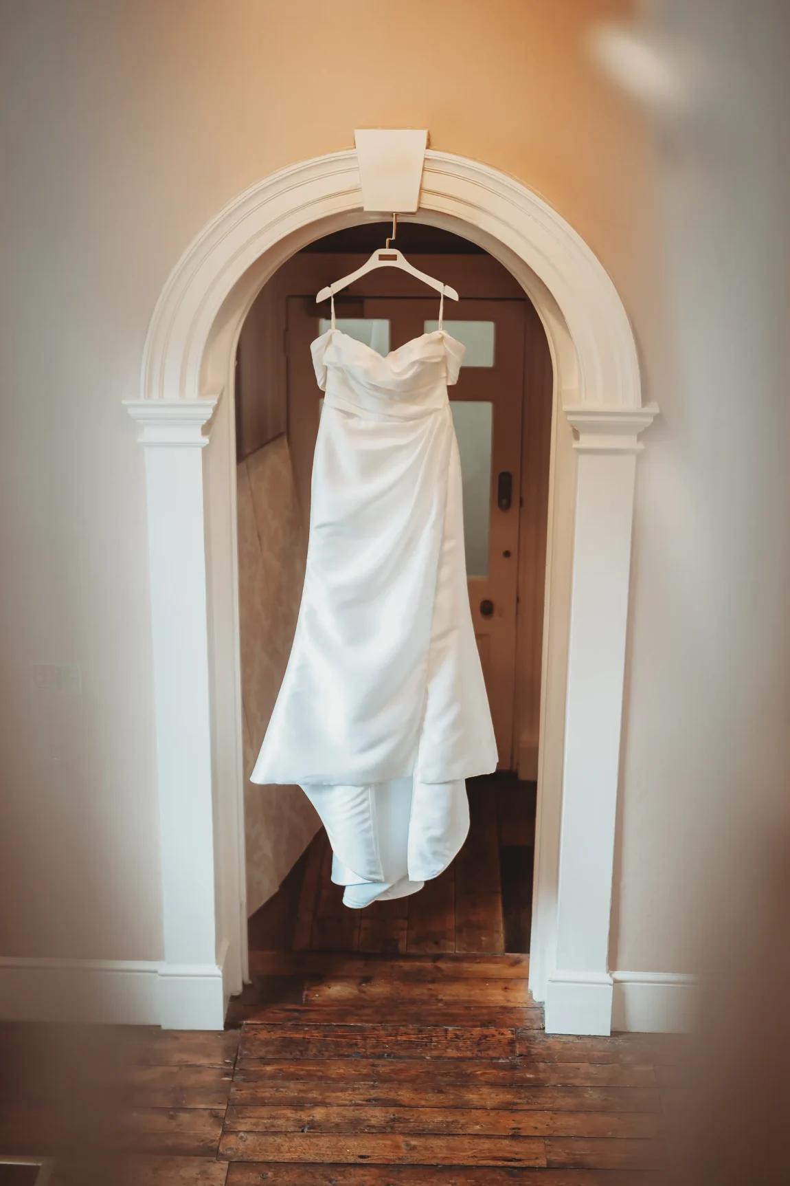 Emily & Alan / The Orangery 3 Emily’s wedding dress hanging in the brick archway at The Orangery Maidstone