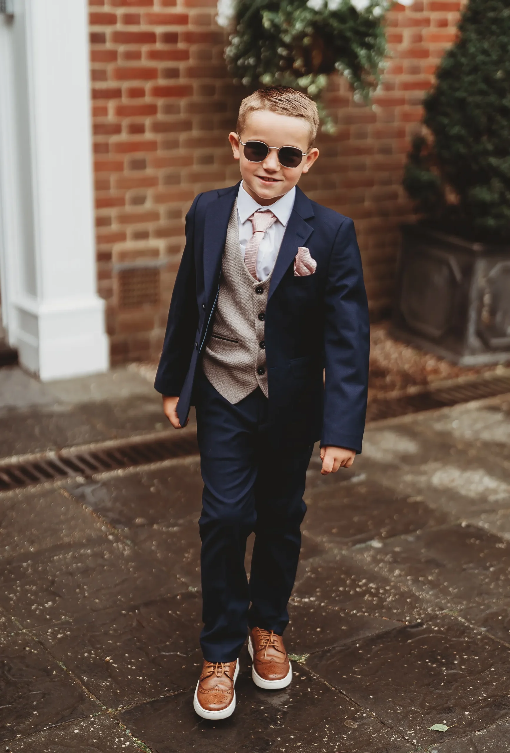 Emily & Alan / The Orangery 10 Page boy in sunglasses walking up the drive at The Orangery Maidstone