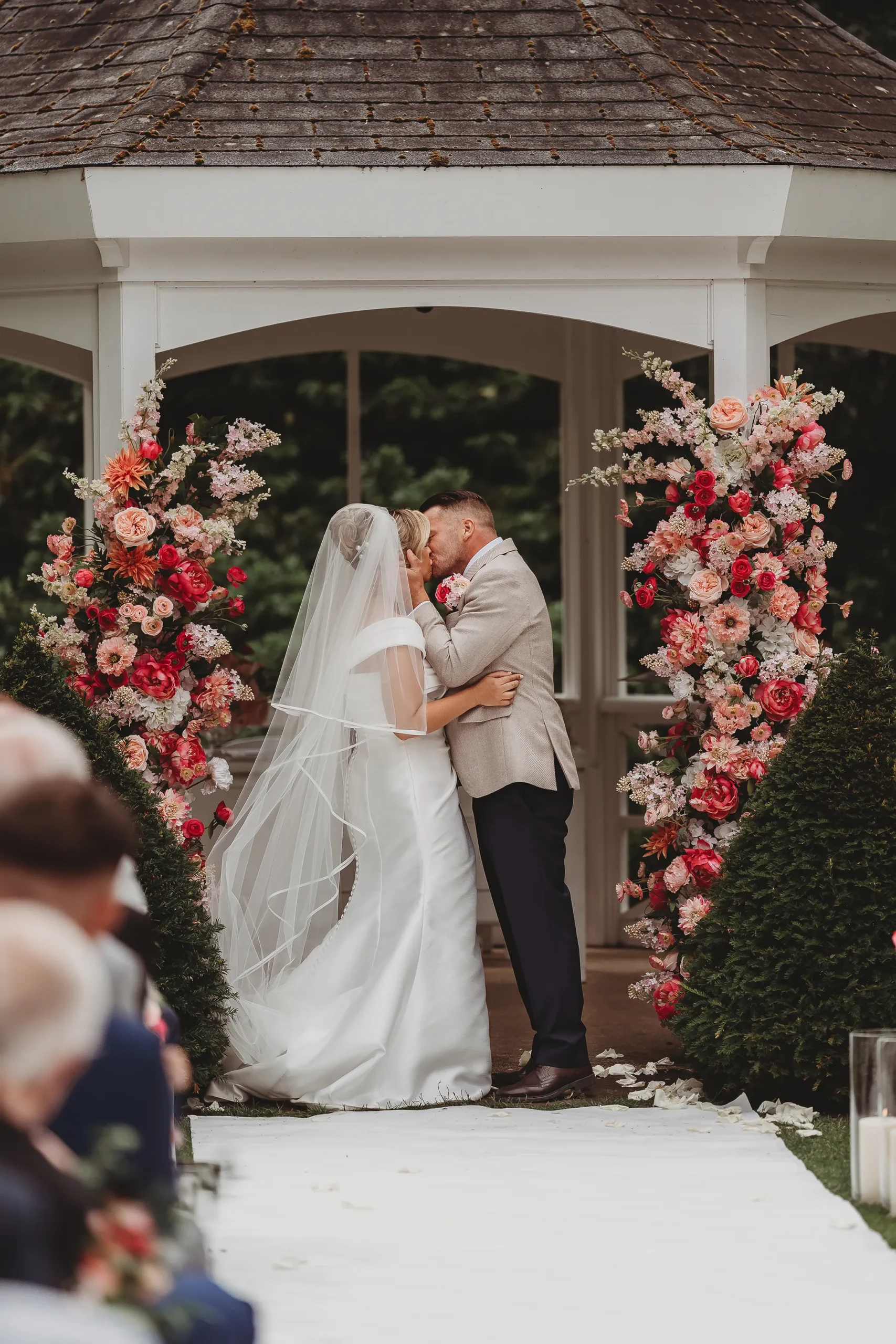 Emily & Alan / The Orangery 20 First kiss as husband and wife under the floral arch at The Orangery Maidstone
