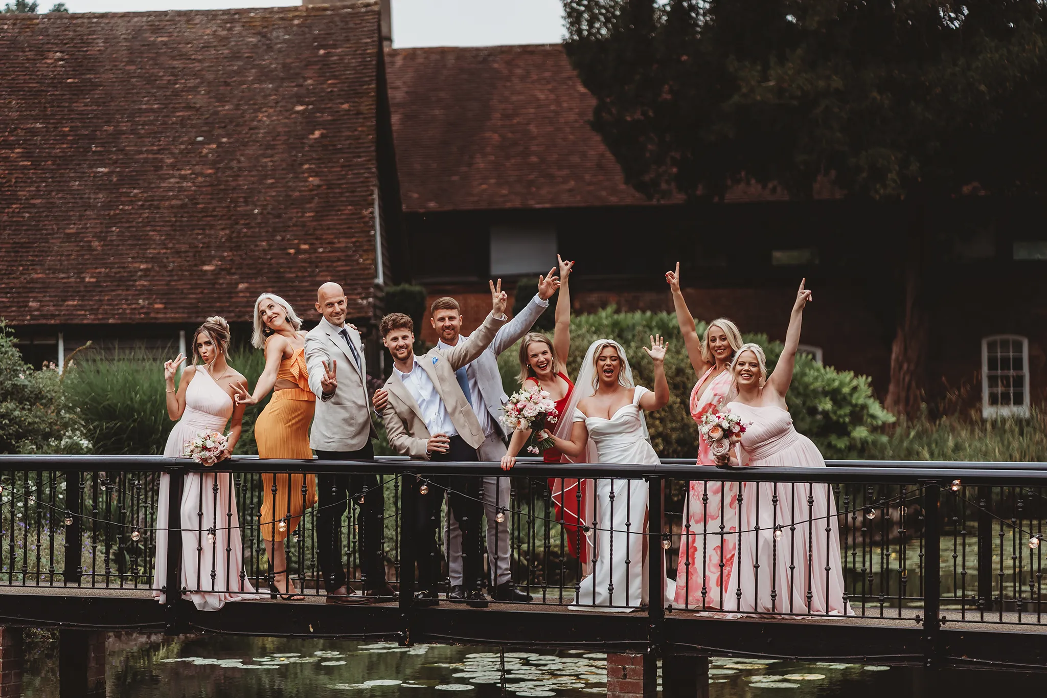 Emily & Alan / The Orangery 26 Big group photo on the bridge over the lake at The Orangery Maidstone