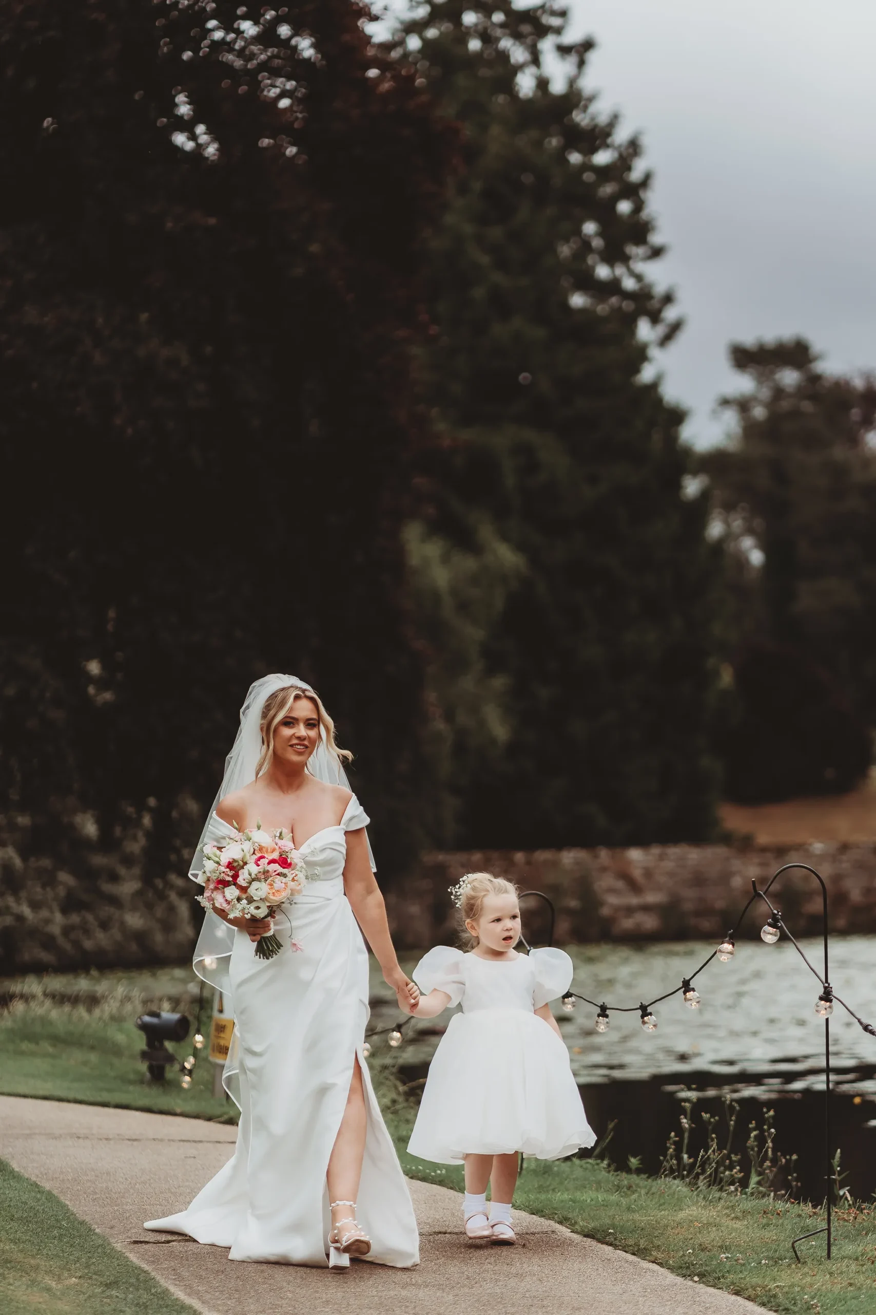 Emily & Alan / The Orangery 27 Emily walking by the lake with her flower girl