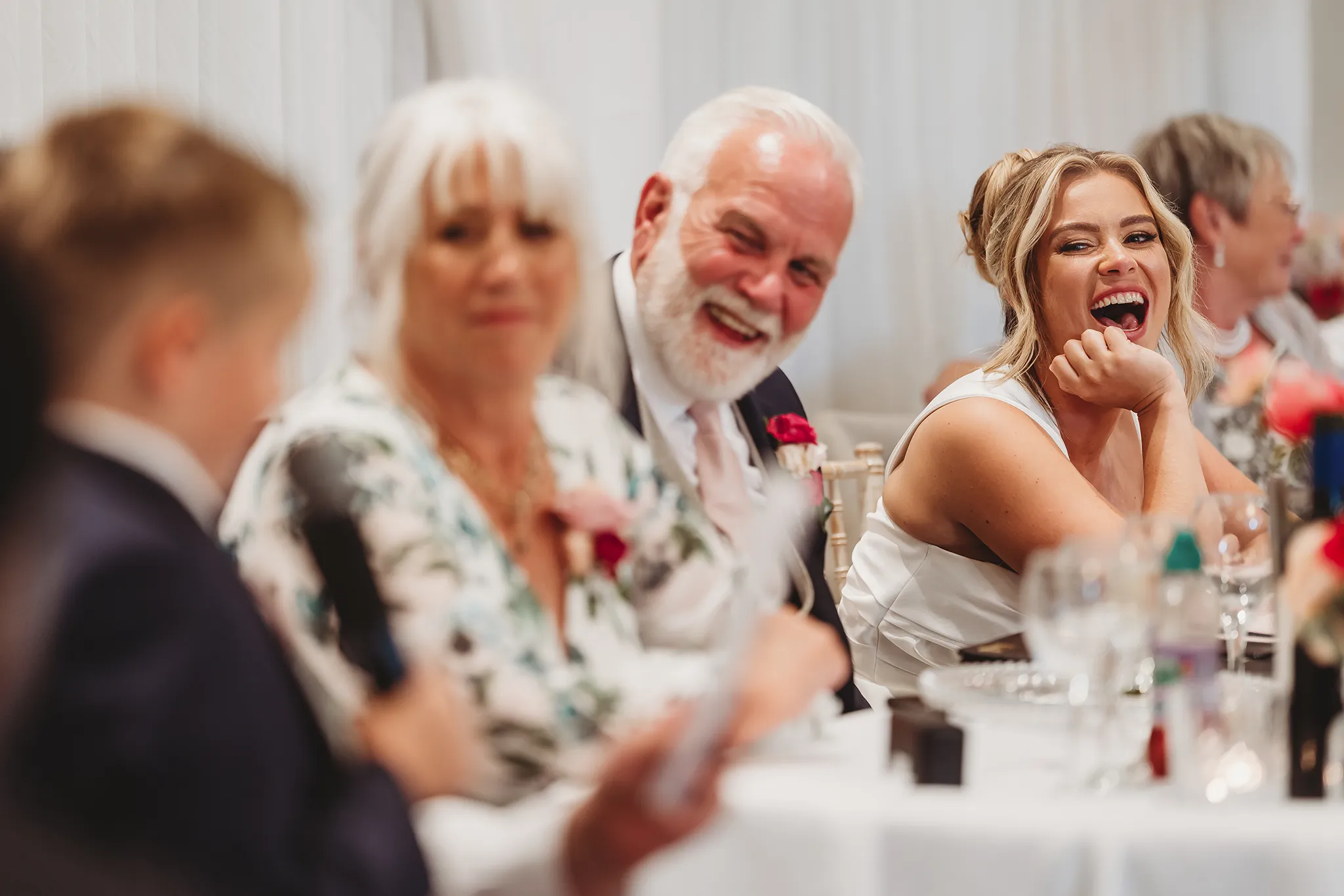 Emily & Alan / The Orangery 35 Guests laughing during the wedding speeches at The Orangery
