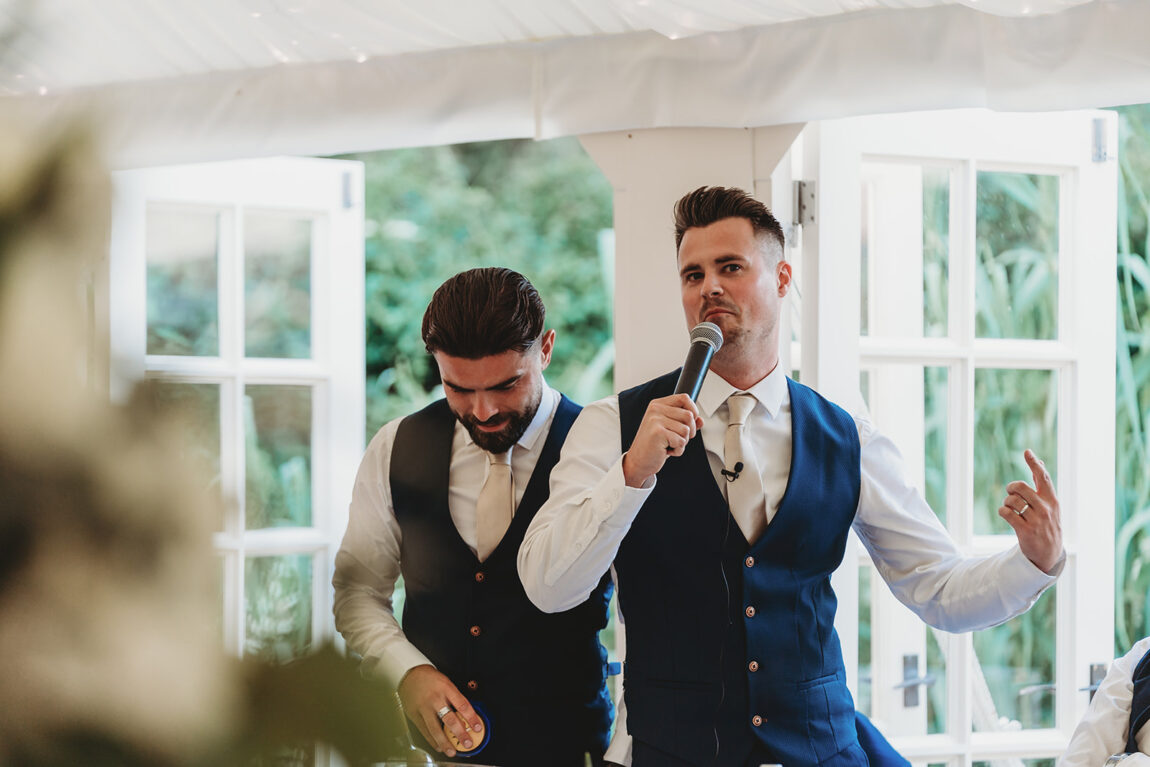 Best men mid-speech in the marquee at Le Talbooth