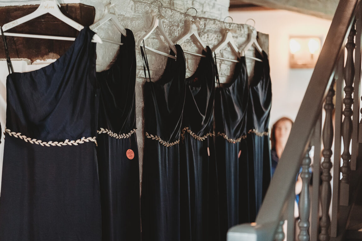 Navy bridesmaid dresses hanging on the wedding morning