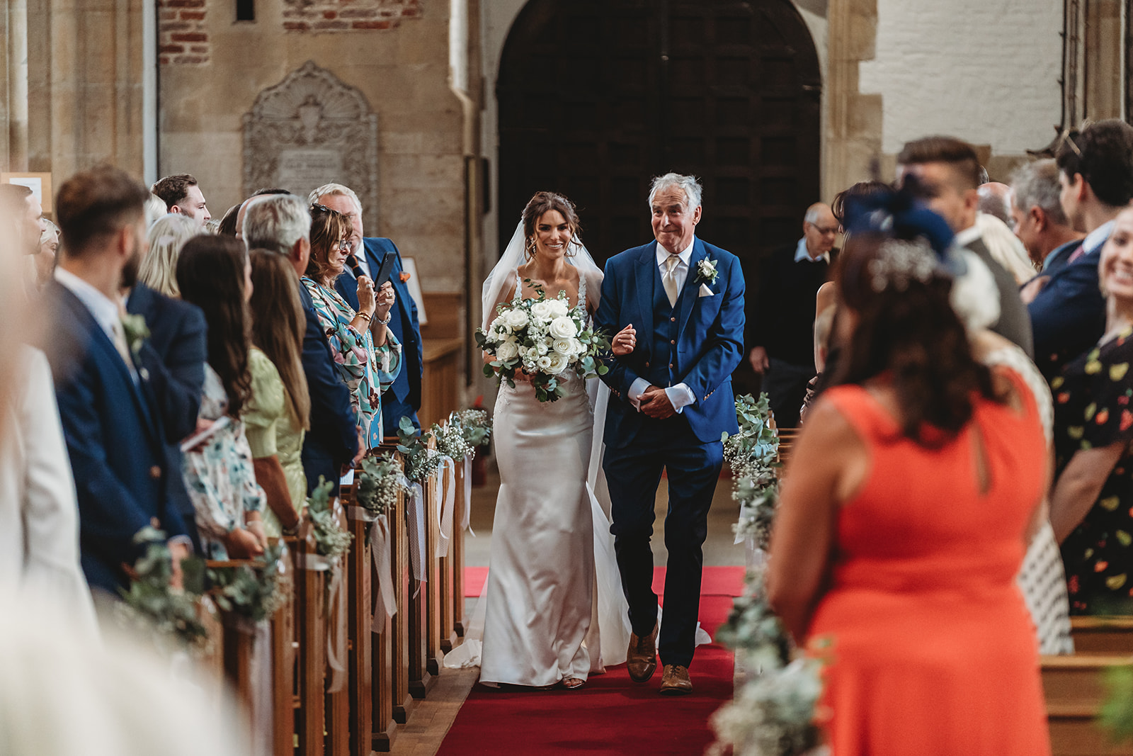 Bride walking down the aisle with her father at the church ceremony