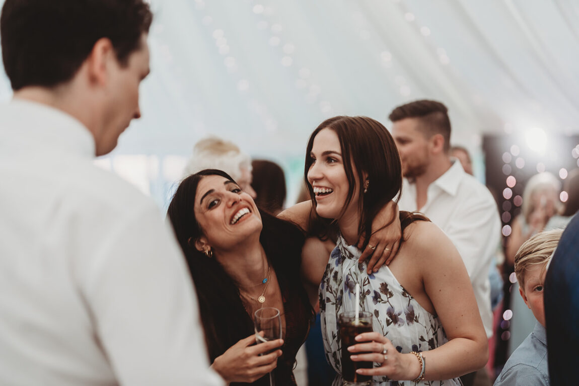 Guests laughing on the dancefloor in the evening at Le Talbooth