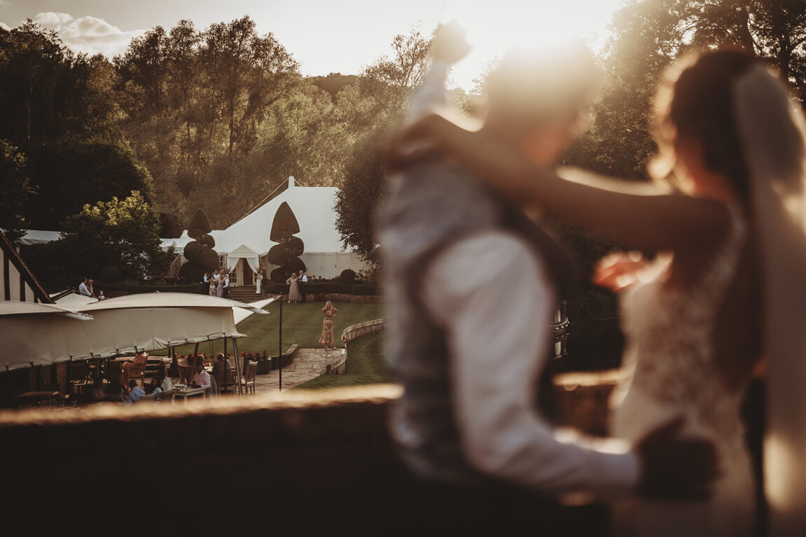 Evening light over the marquee and gardens at Le Talbooth, the couple in the foreground