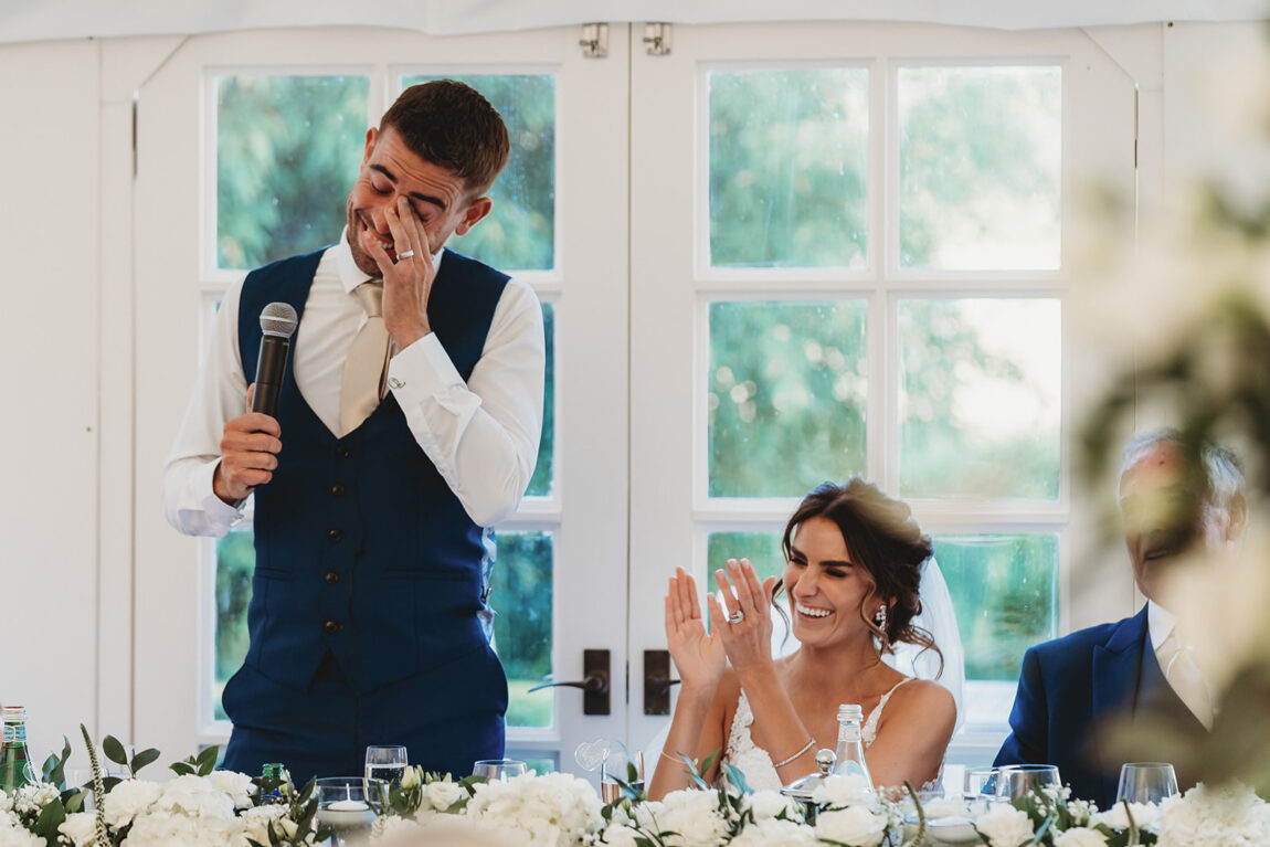 Groom wiping away tears during his speech in the marquee at Le Talbooth
