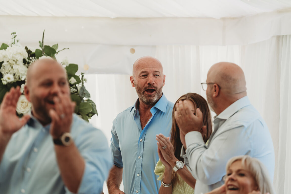 Guests cheering in the marquee at Le Talbooth