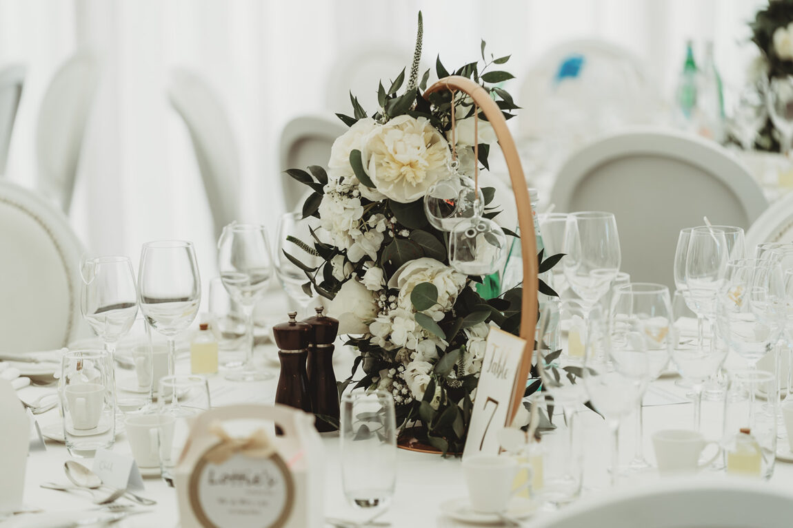 White flowers on the wedding breakfast tables in the marquee at Le Talbooth