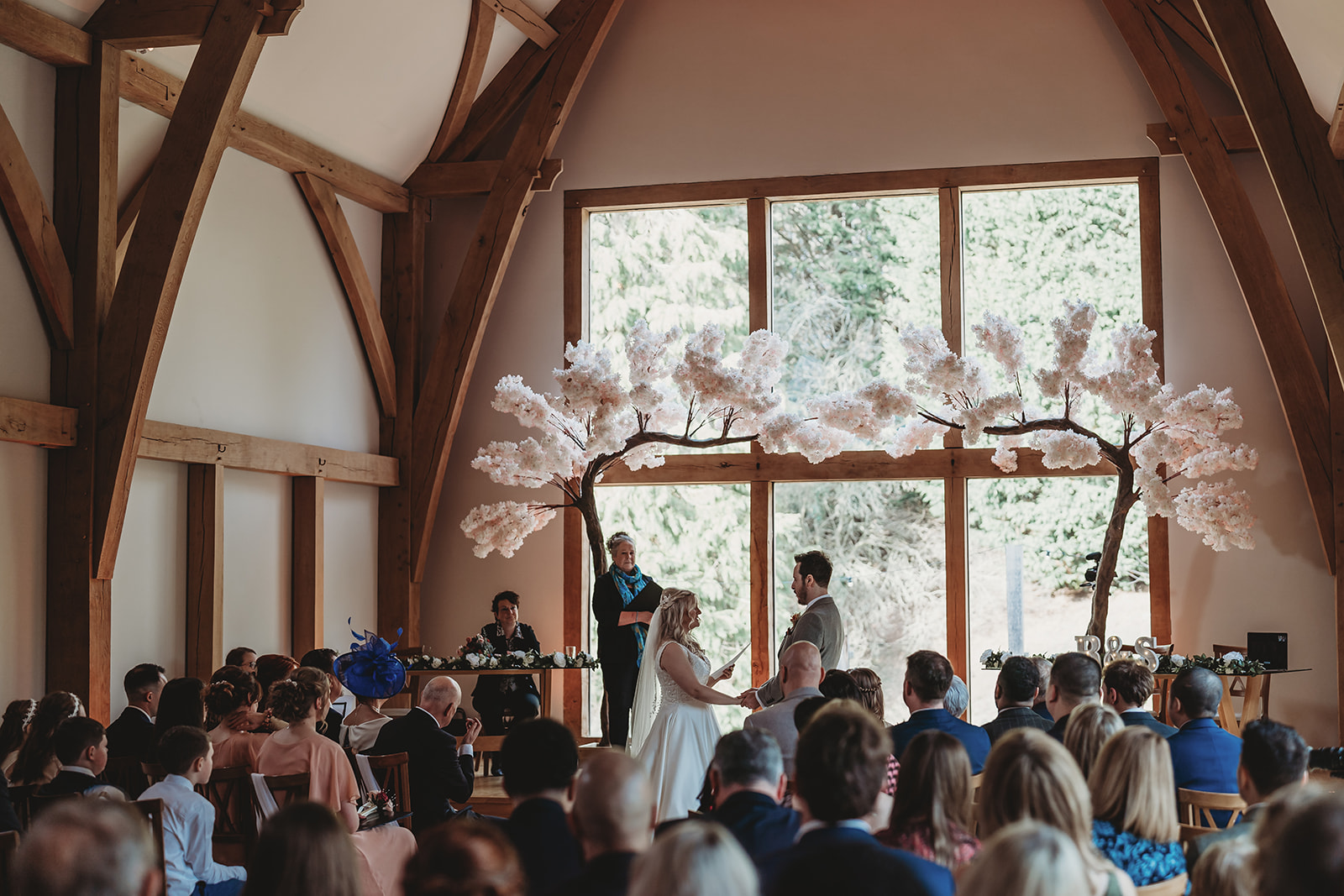 Wedding ceremony under the oak beams at The Mill Barns, Alveley