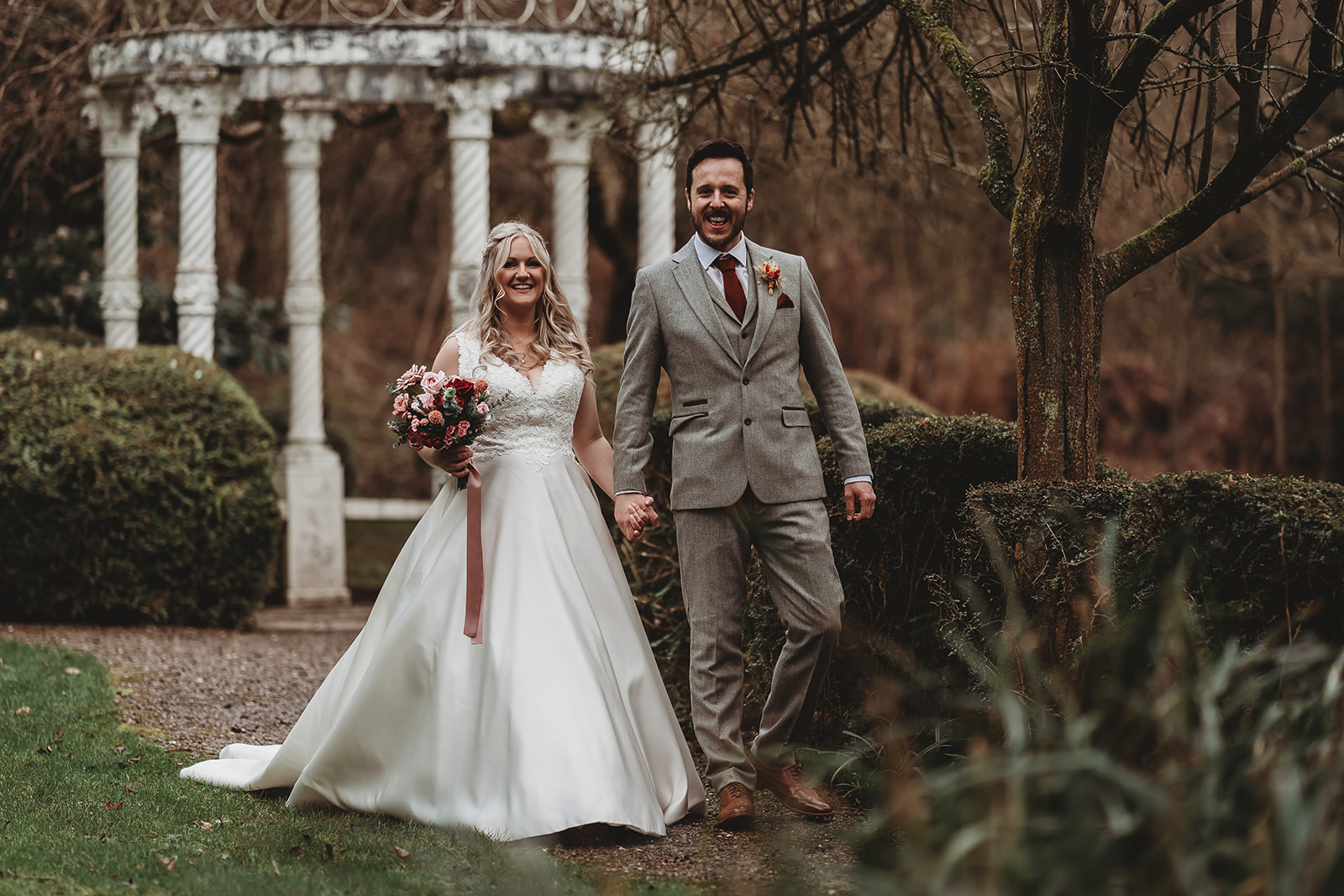 Bride and groom walking through the gardens at The Mill Barns, Shropshire
