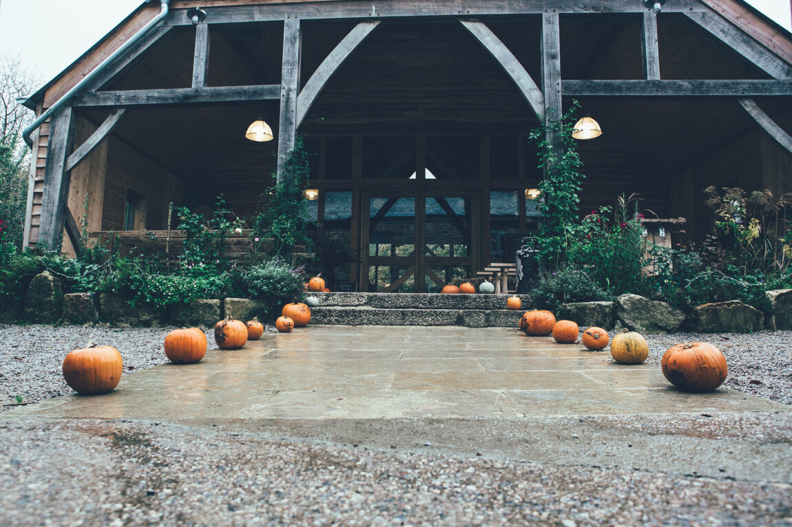 Ceremony barn at Nancarrow Farm with pumpkins lining the aisle