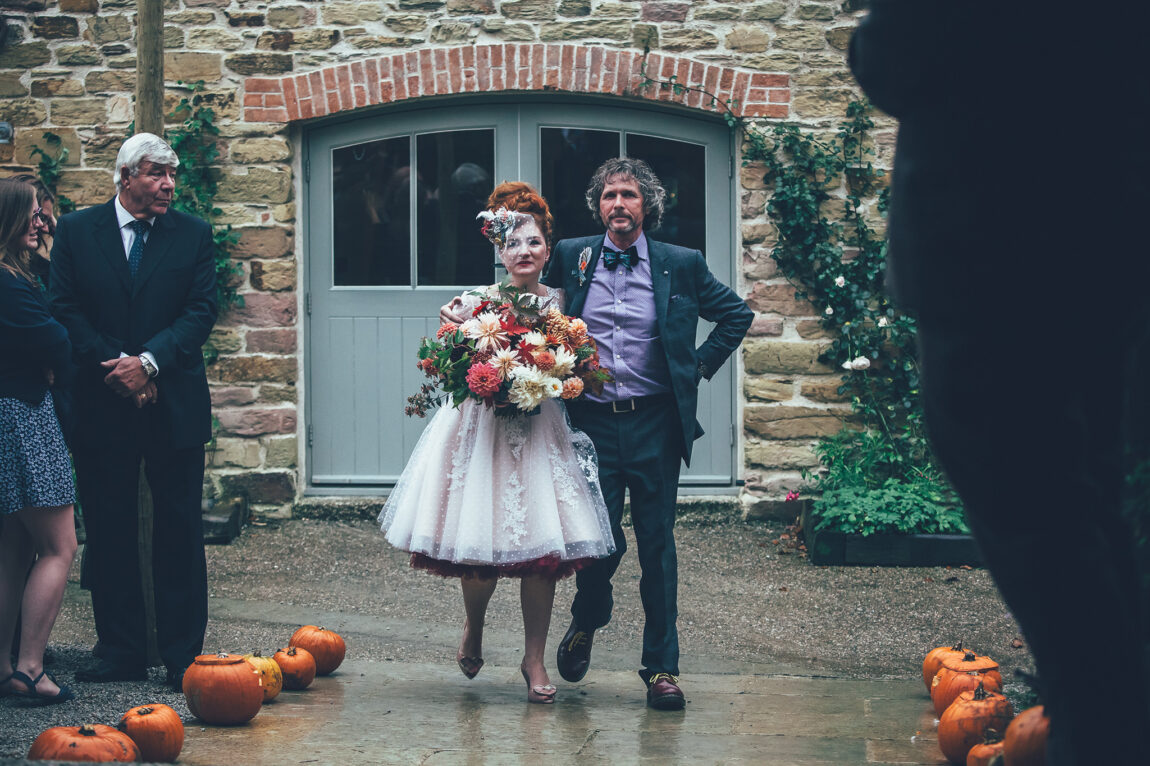 Bride arriving with her father at the ceremony barn at Nancarrow Farm