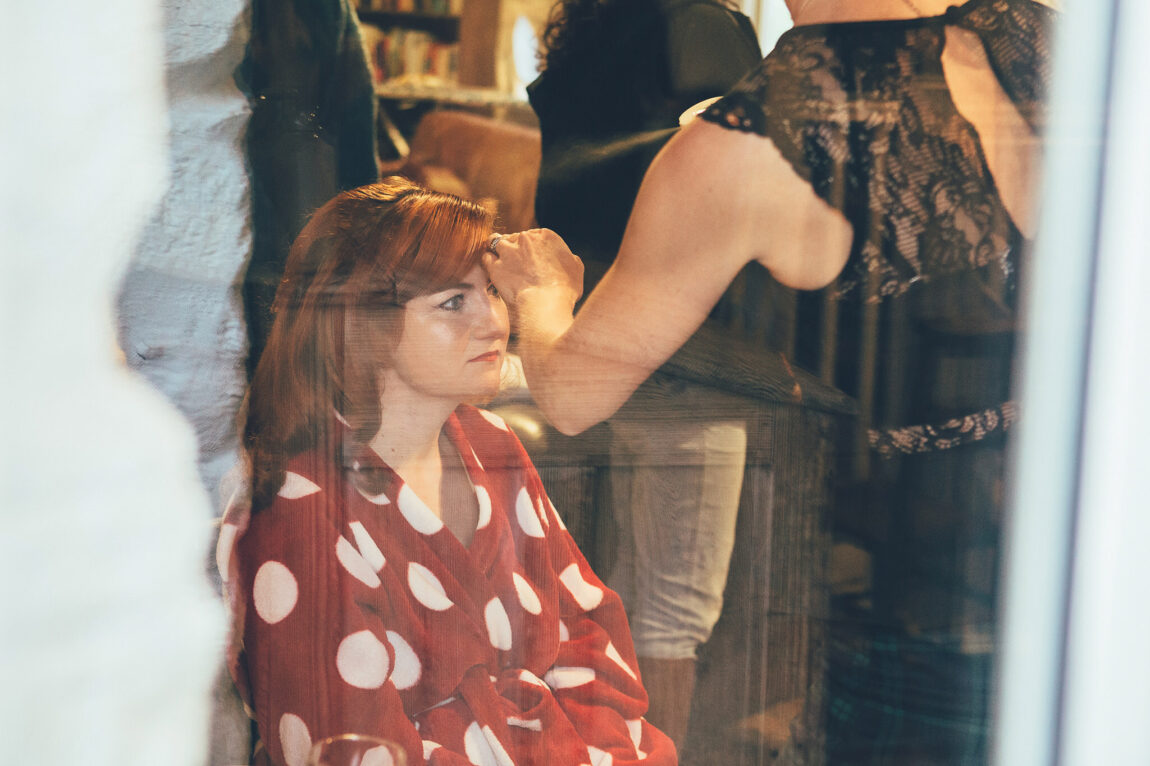 Bride having her hair done in a polka dot dress at Nancarrow Farm