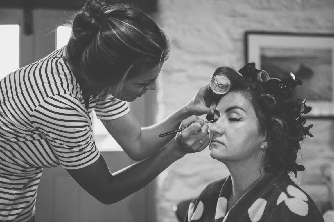 Bride having her make-up done on the wedding morning at Nancarrow Farm