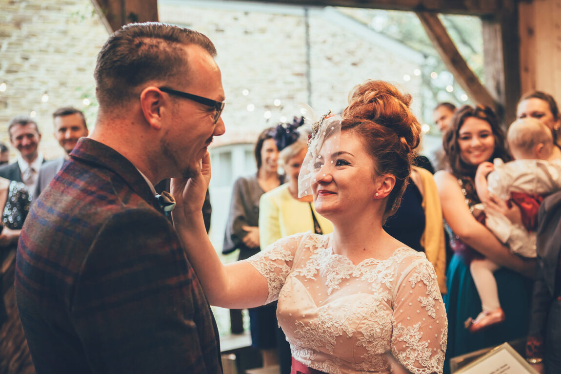 Bride and groom during their vows in the barn at Nancarrow Farm