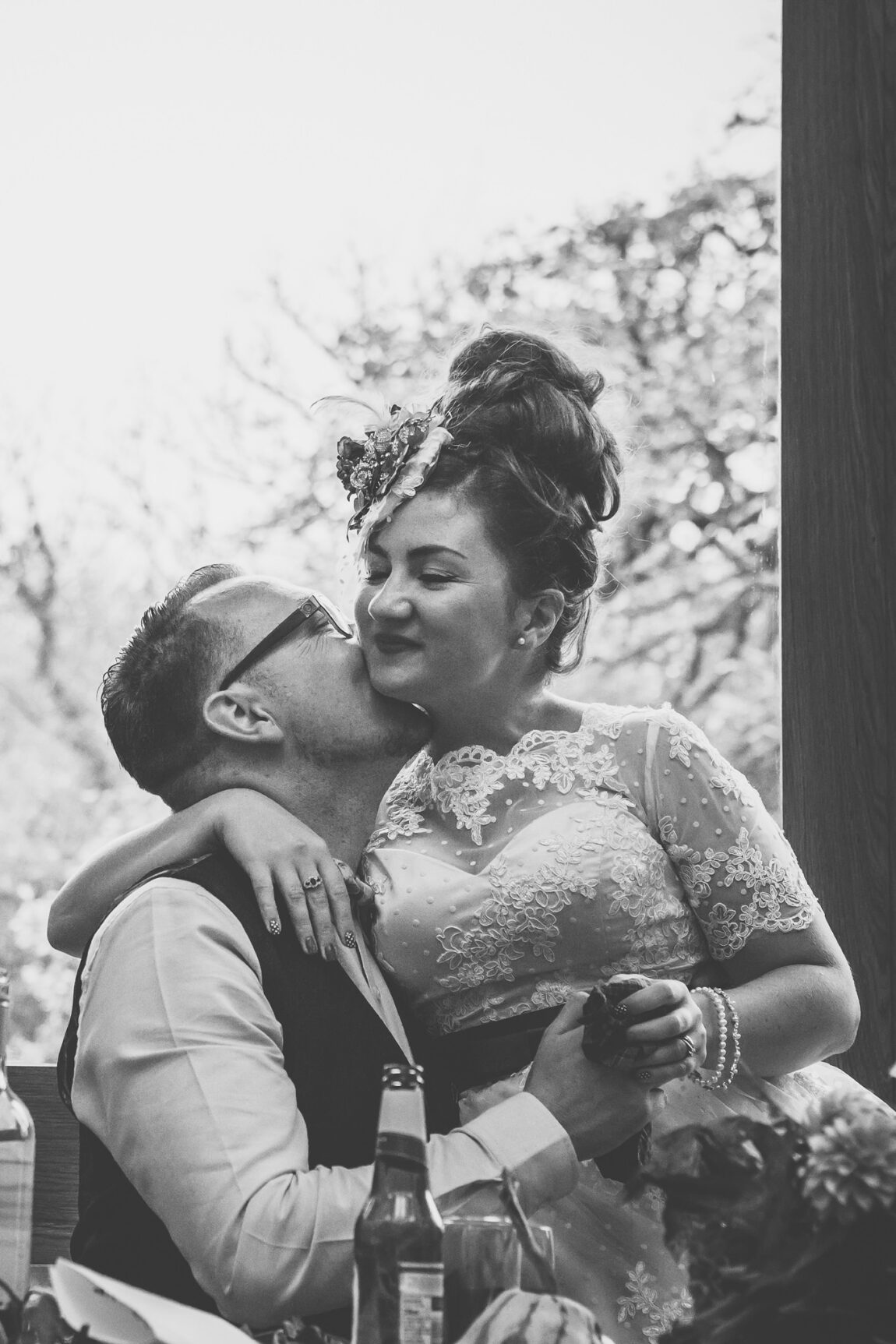 Black and white of the groom kissing the bride at Nancarrow Farm