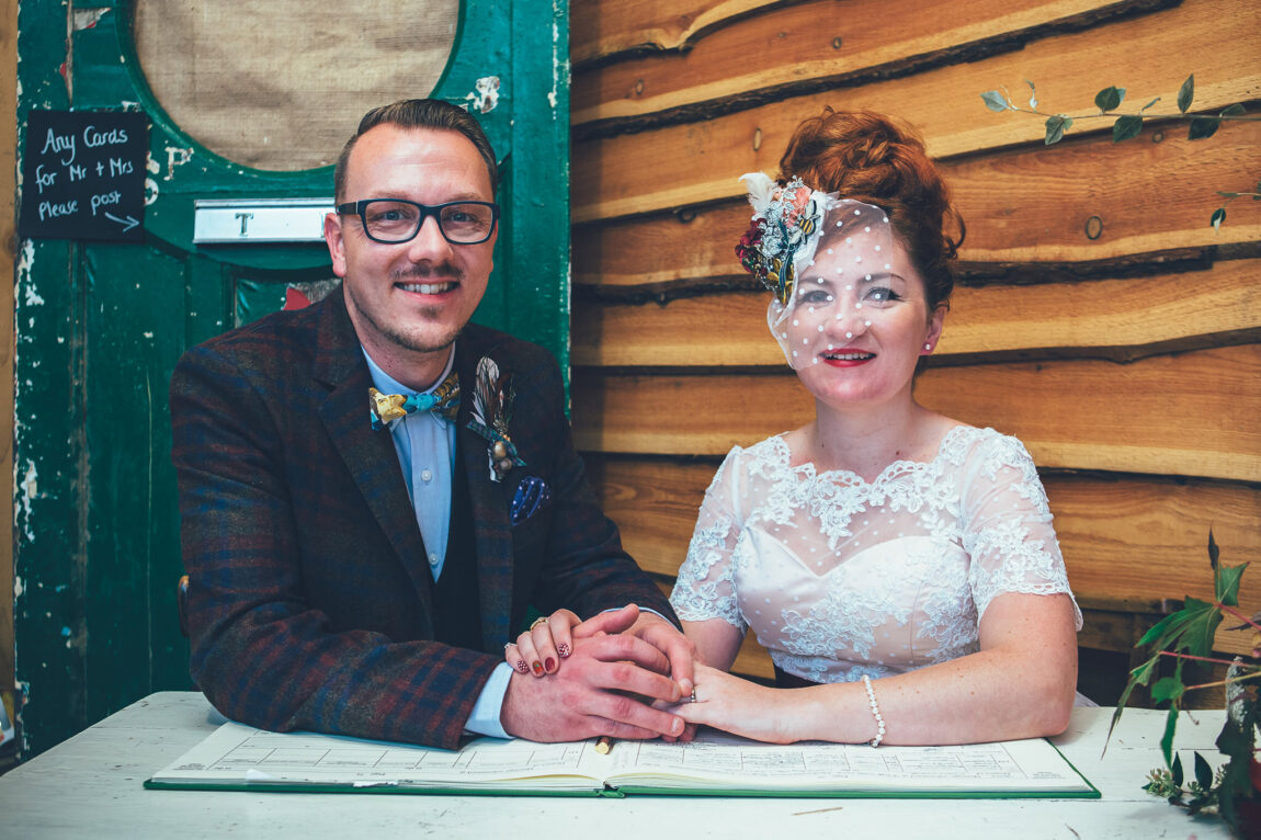 Bride and groom signing the register at Nancarrow Farm