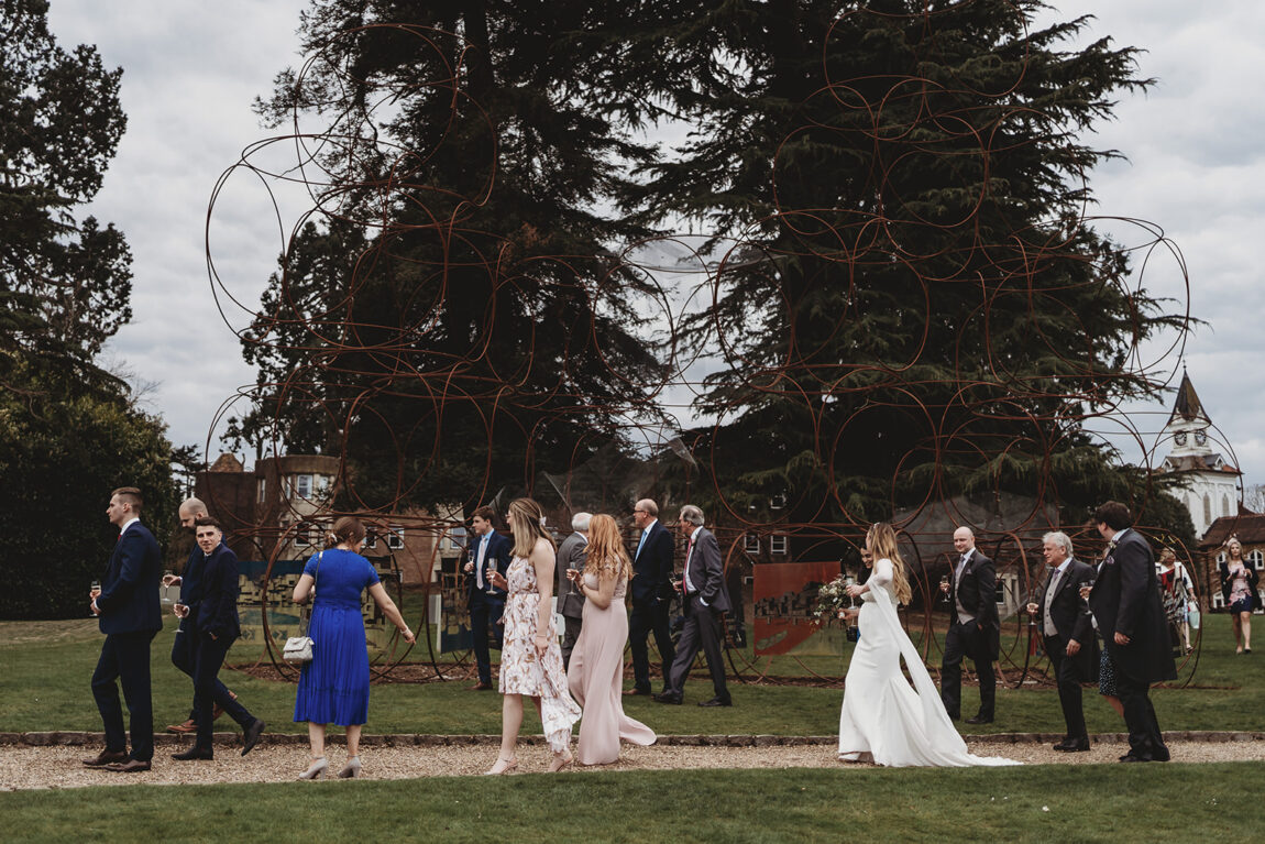Guests walking across the lawn at an Oakley Court wedding