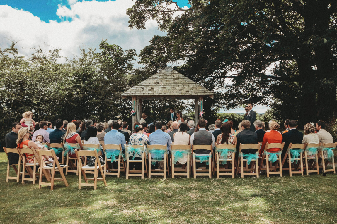 Outdoor ceremony on the arbour lawn under the sycamore at Trevenna