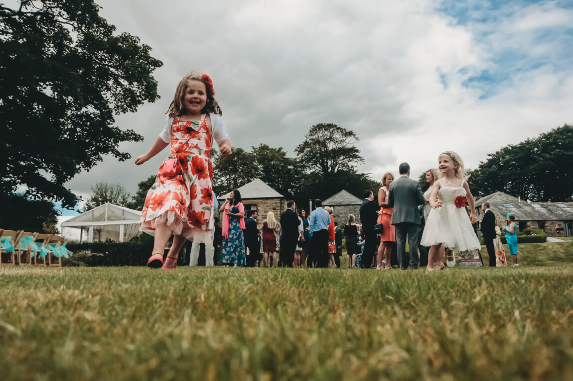 Little girl dancing on the lawn during the drinks at Trevenna